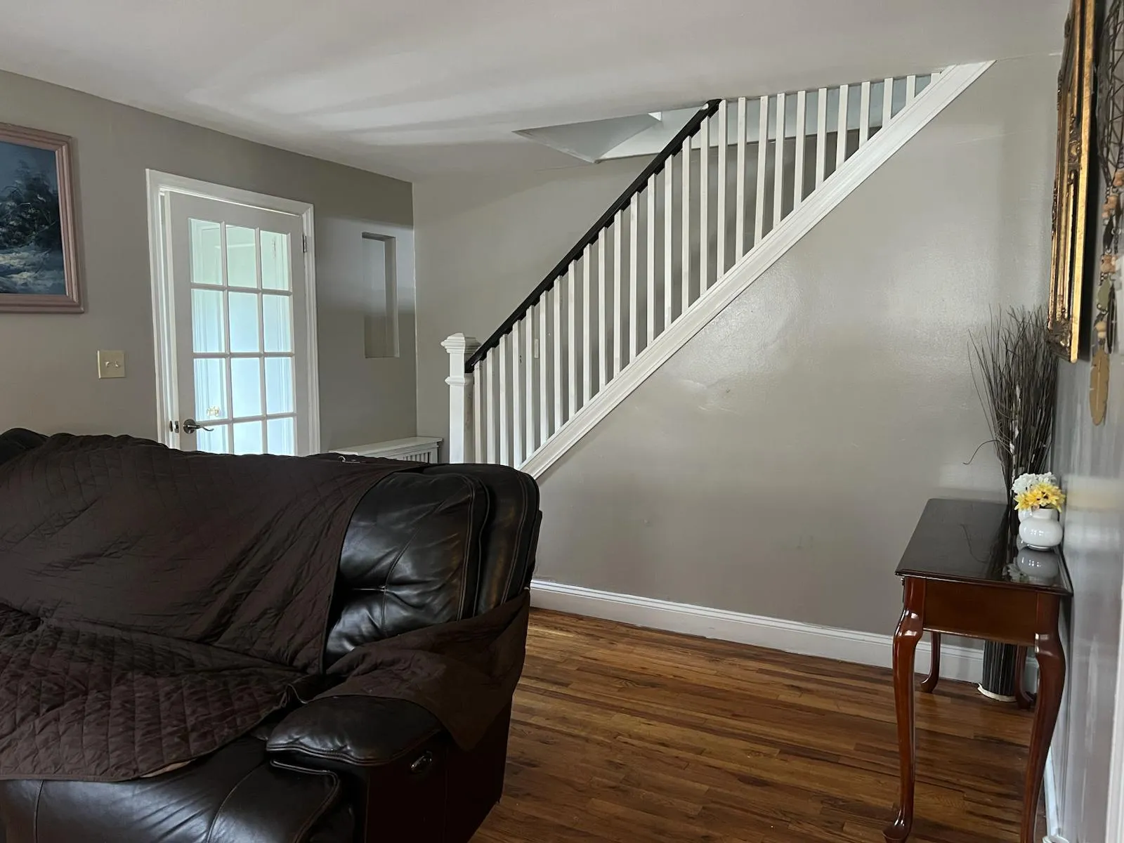 Living room featuring wood finished floors and stairway Living room featuring wood finished floors and stairway
