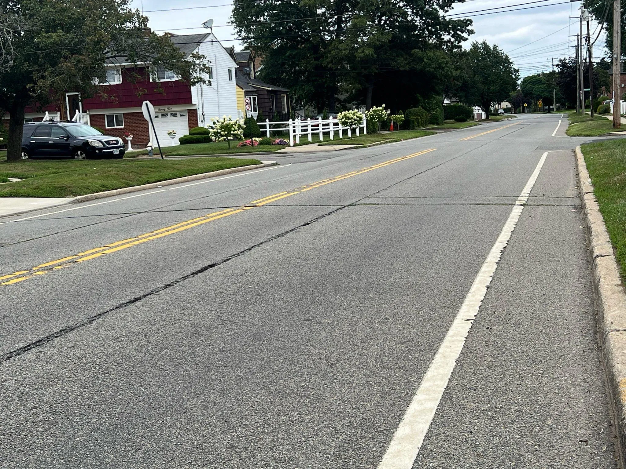 View of asphalt road featuring curbs View of asphalt road featuring curbs