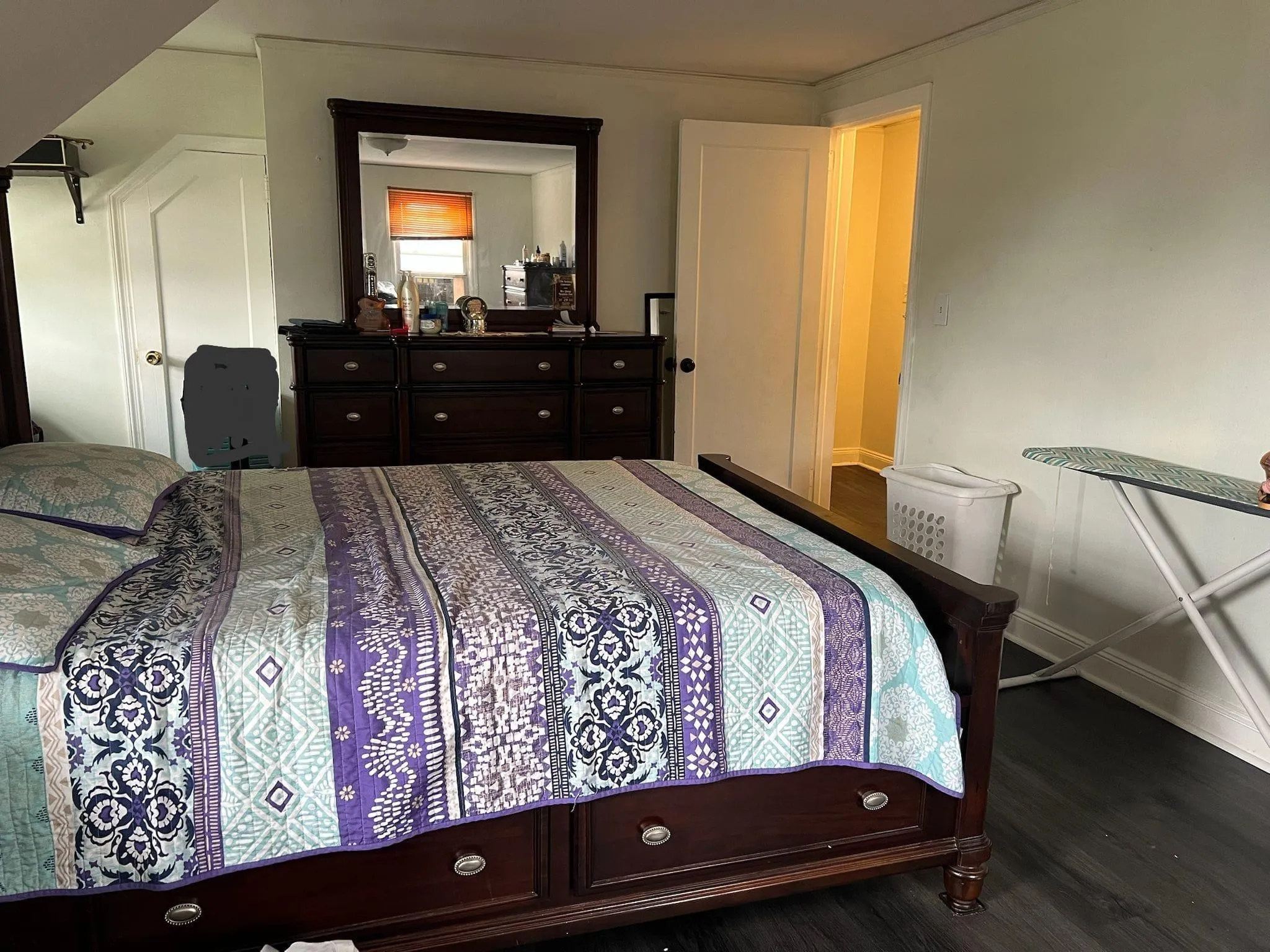 Bedroom featuring dark wood finished floors and baseboards Bedroom featuring dark wood finished floors and baseboards