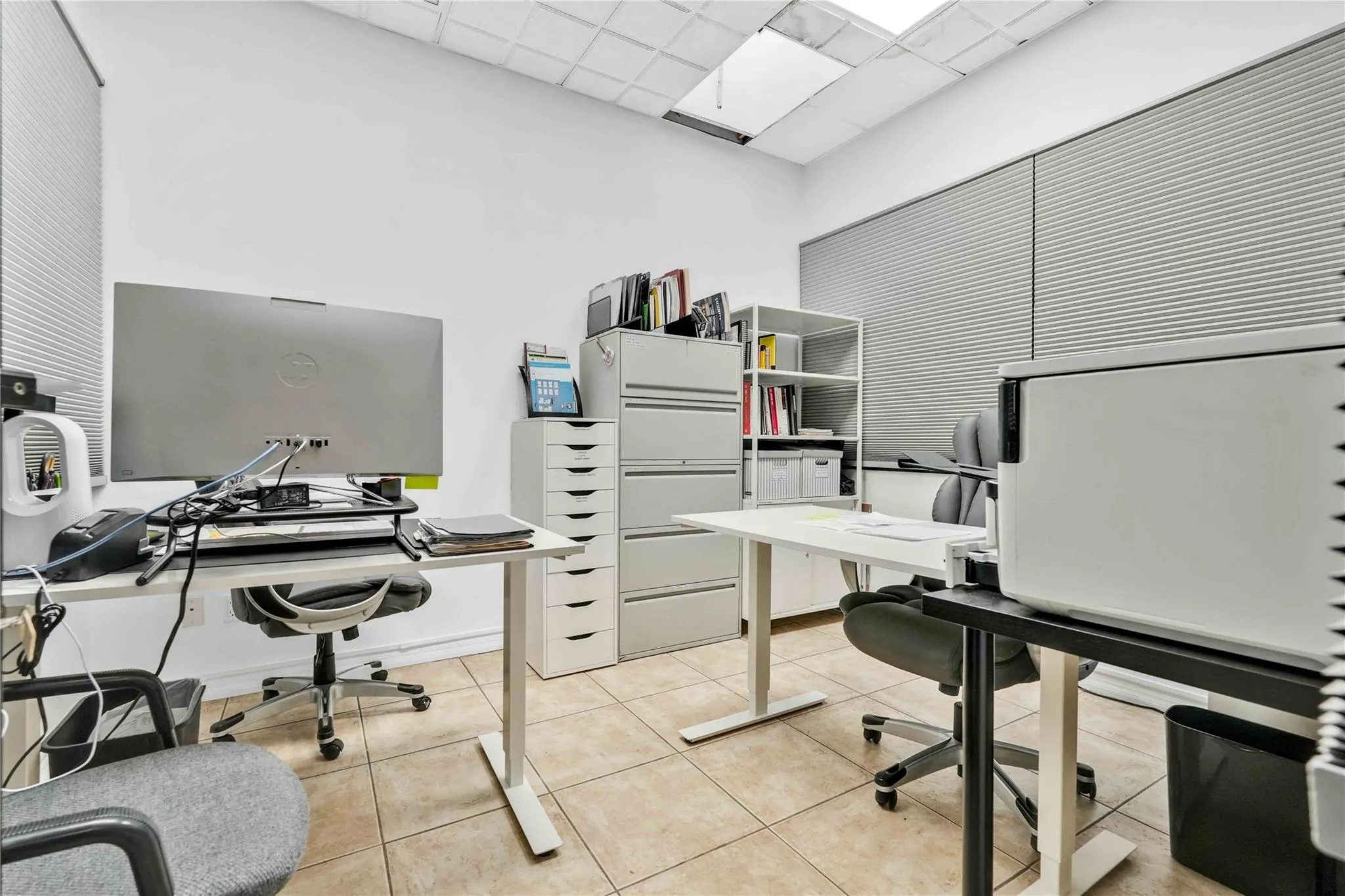 Home office with light tile patterned floors and a drop ceiling Home office with light tile patterned floors and a drop ceiling