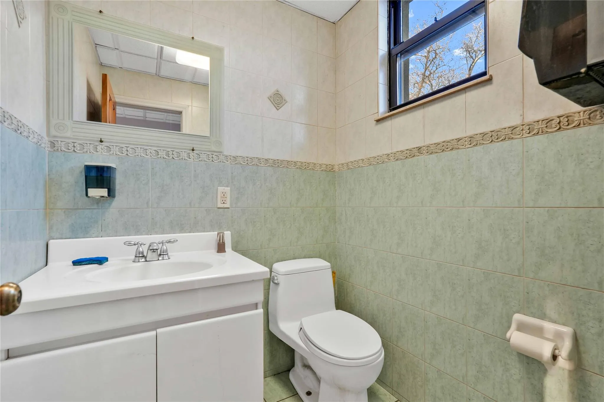 Bathroom featuring vanity and tile walls Bathroom featuring vanity and tile walls