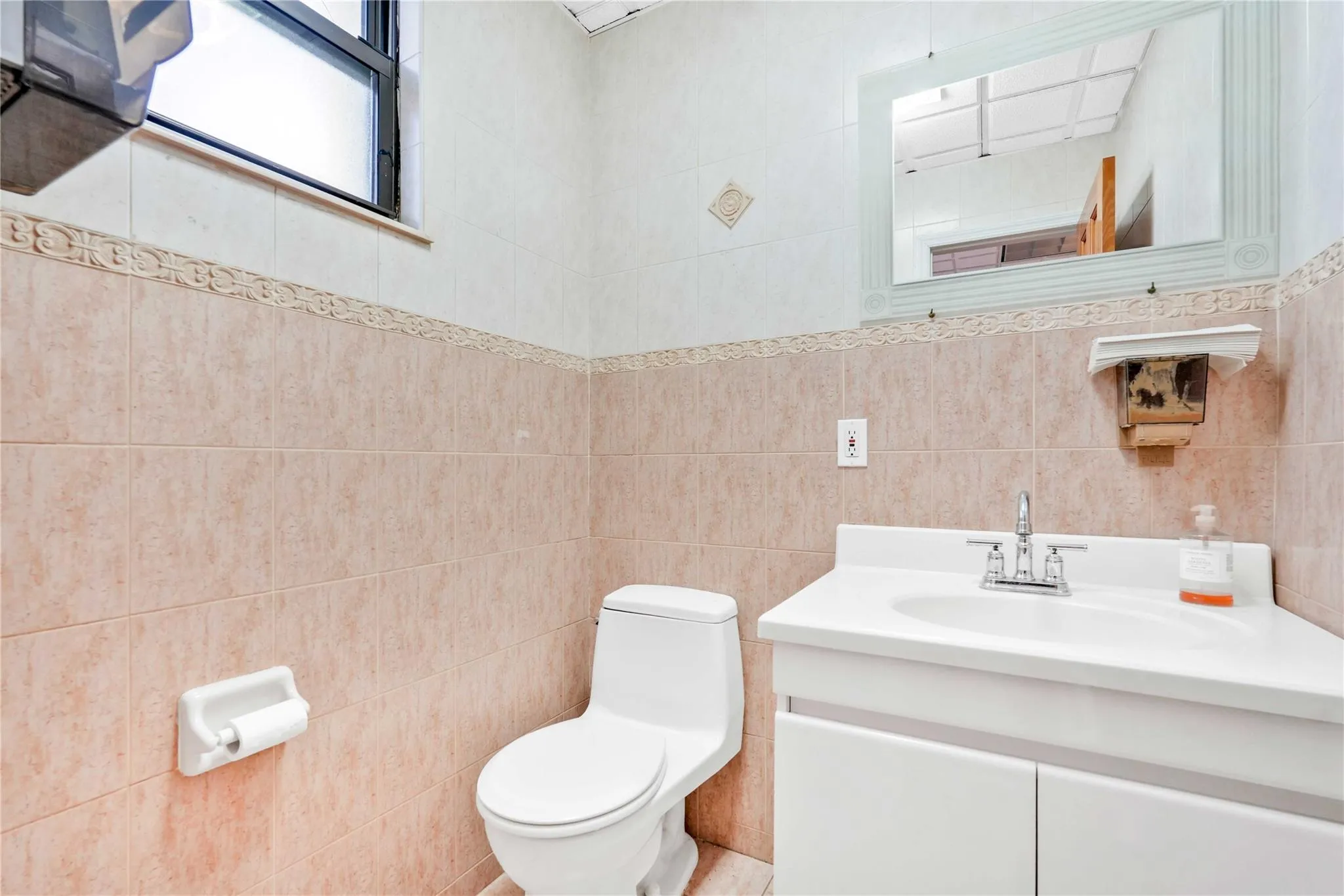 Half bath with vanity and tile walls Half bath with vanity and tile walls