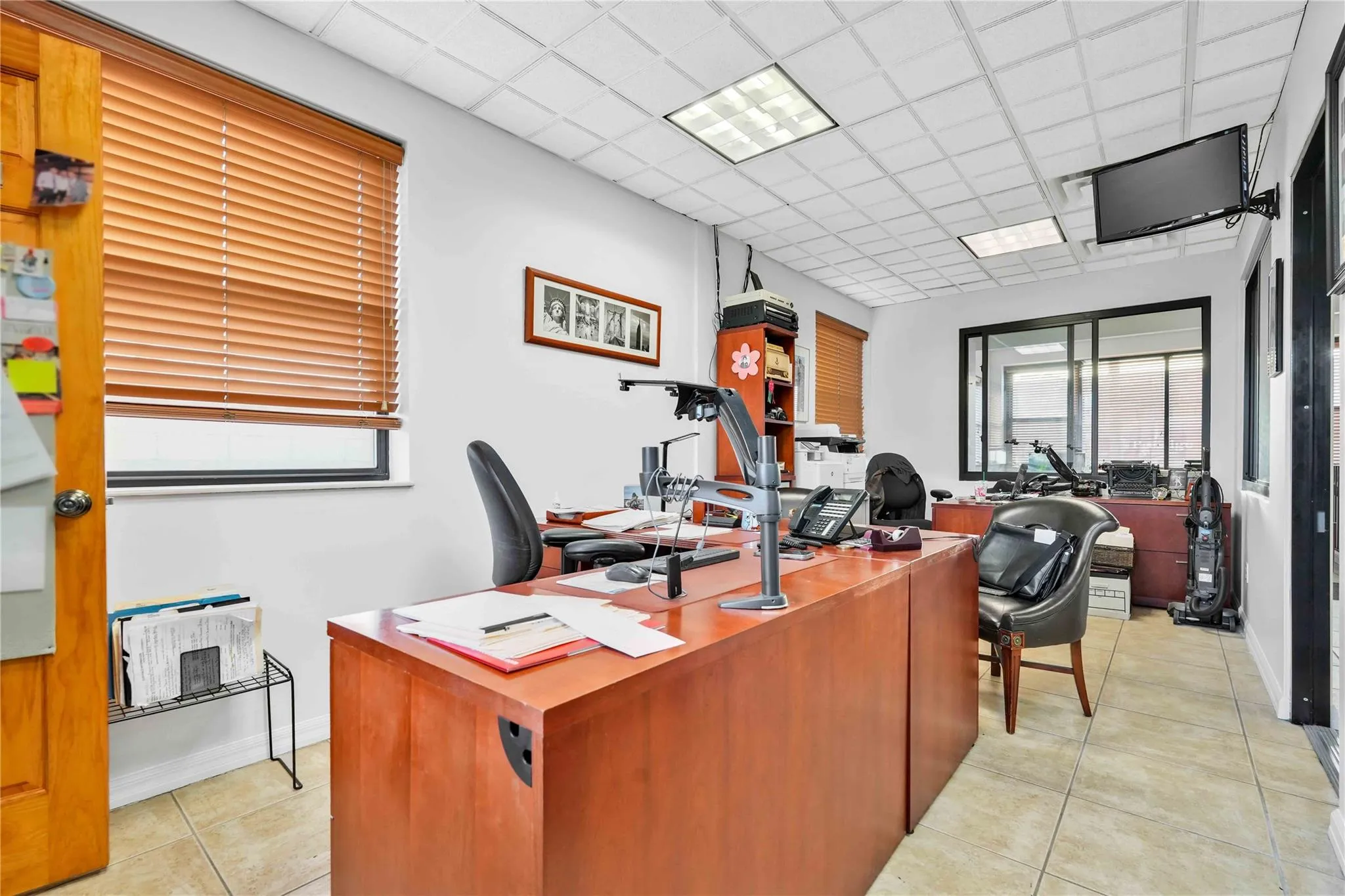 Home office with a paneled ceiling Home office with a paneled ceiling