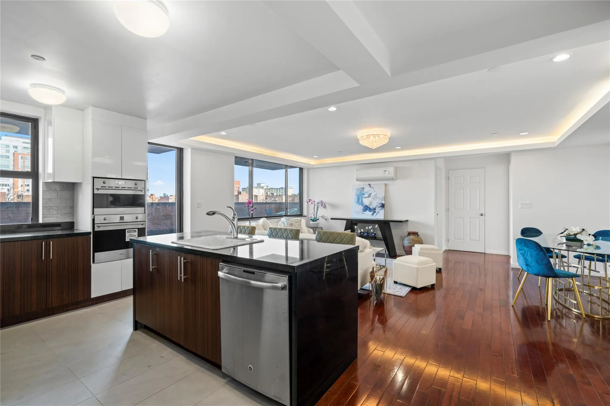 Kitchen with dark brown cabinetry, white cabinetry, dishwasher, sink, and a kitchen island with sink Kitchen with dark brown cabinetry, white cabinetry, dishwasher, sink, and a kitchen island with sink