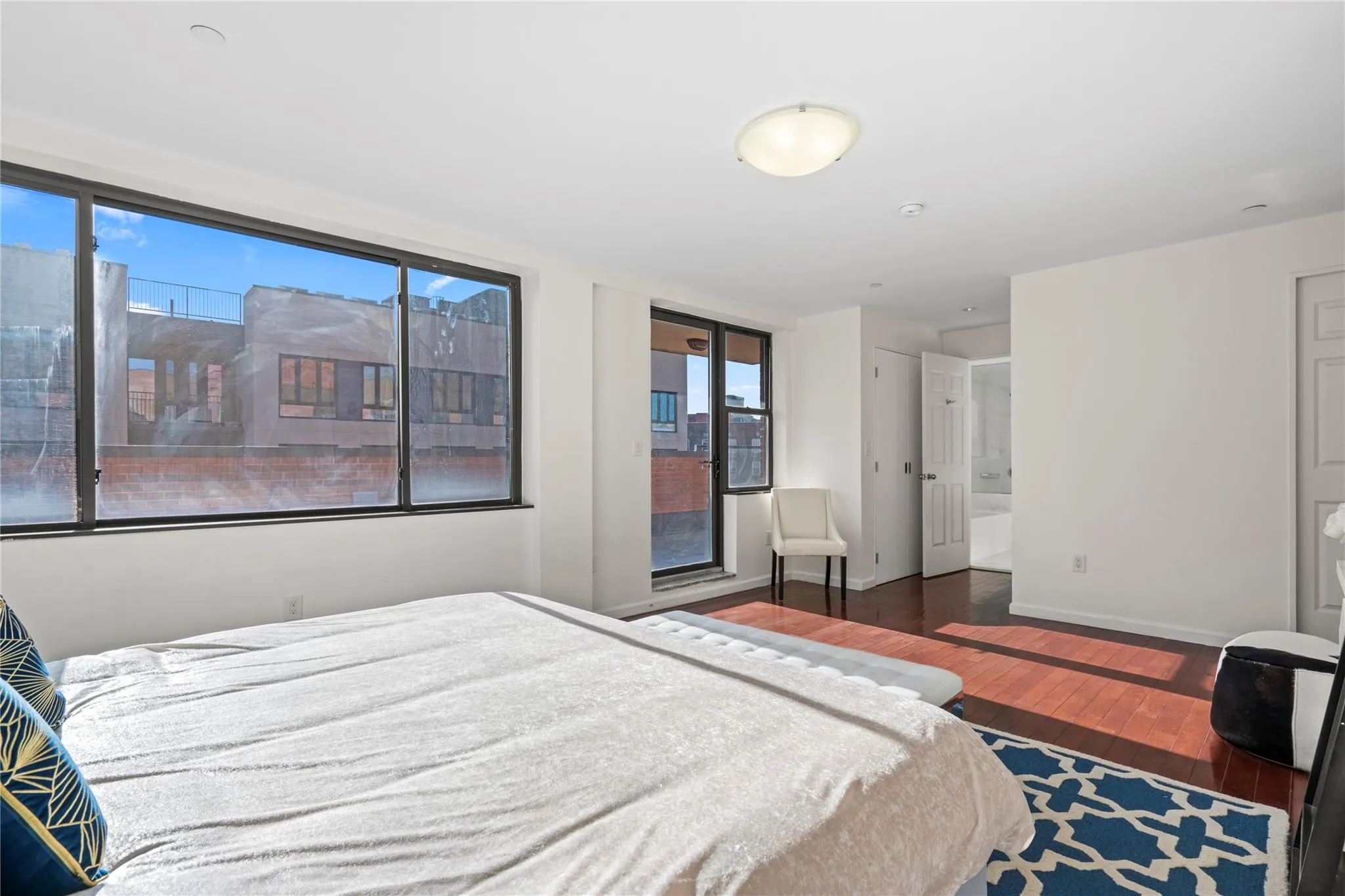 Bedroom with connected bathroom and dark hardwood / wood-style flooring Bedroom with connected bathroom and dark hardwood / wood-style flooring