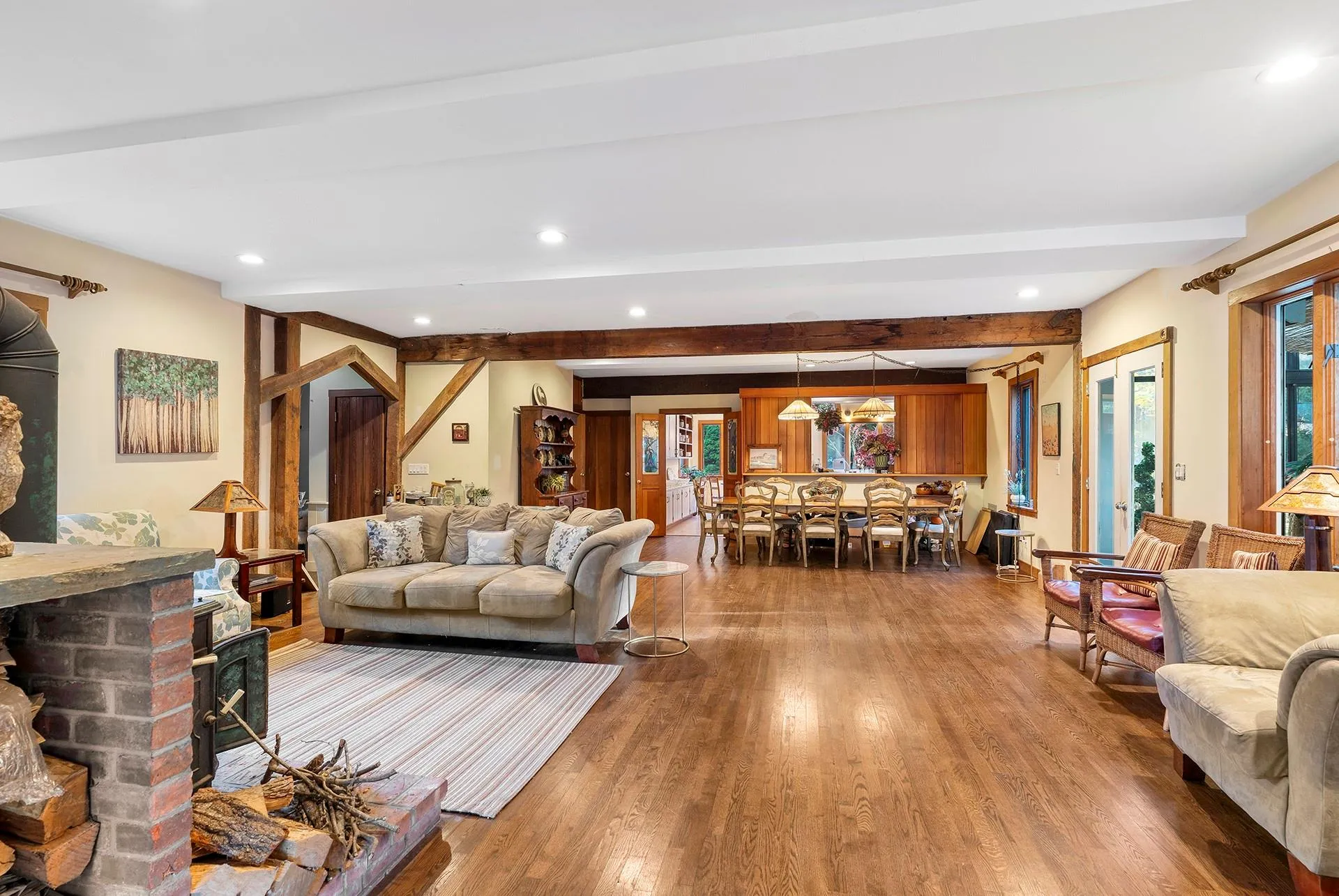 Living room with hardwood / wood-style floors, beam ceiling, and recessed lighting Living room with hardwood / wood-style floors, beam ceiling, and recessed lighting
