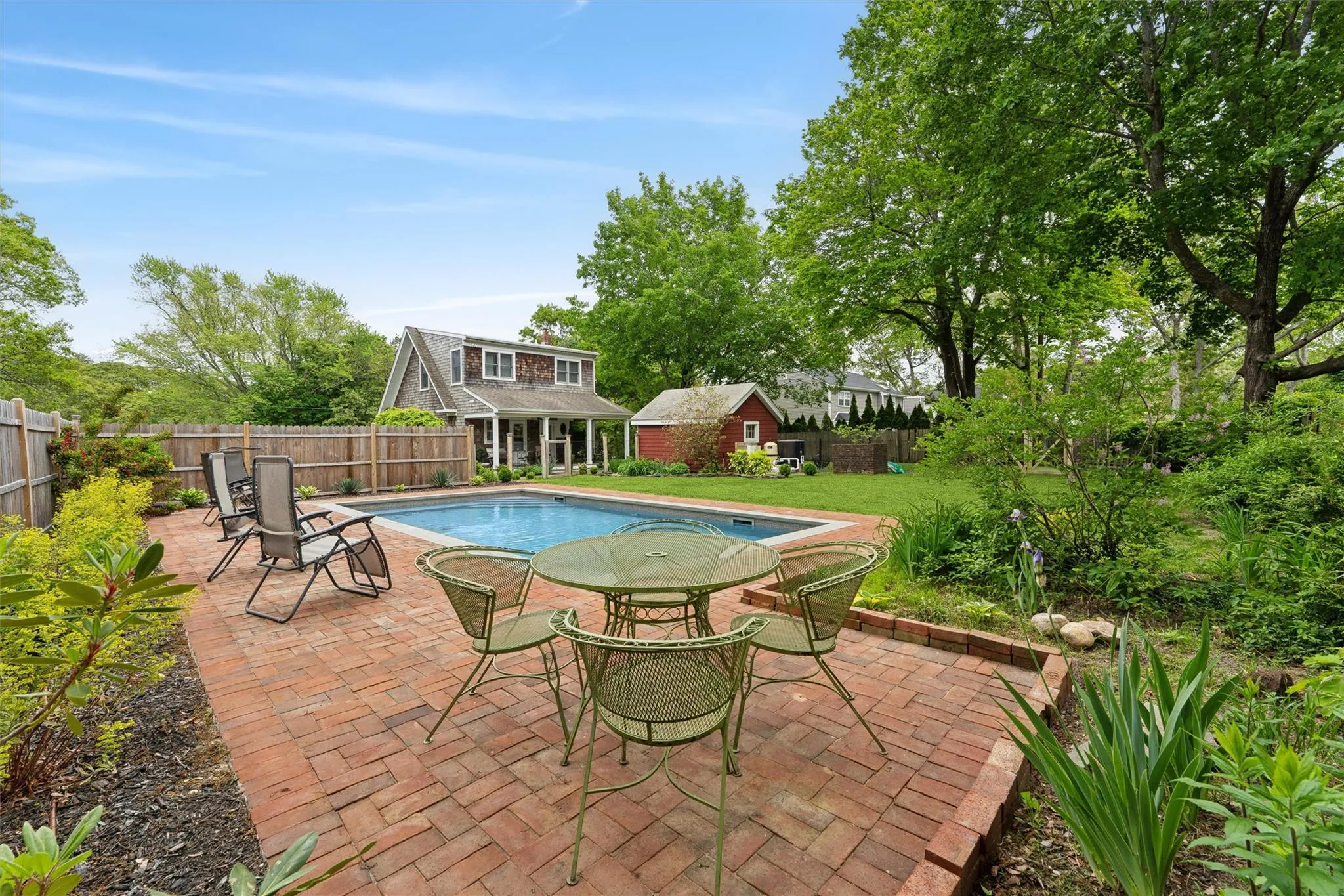 View of swimming pool featuring an exterior structure, a fenced backyard, an outbuilding, and a patio View of swimming pool featuring an exterior structure, a fenced backyard, an outbuilding, and a patio