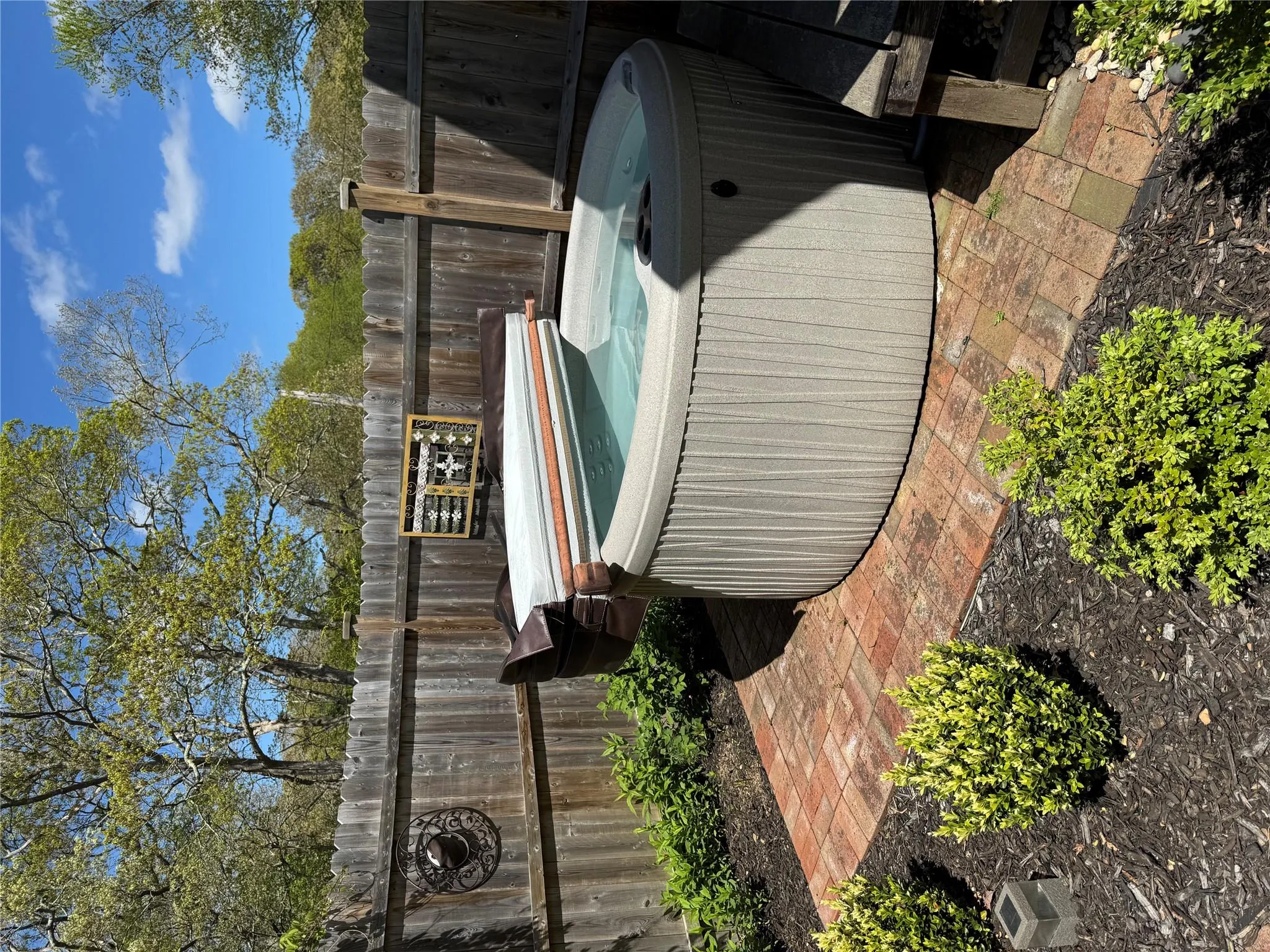View of swimming pool with a hot tub and fence View of swimming pool with a hot tub and fence