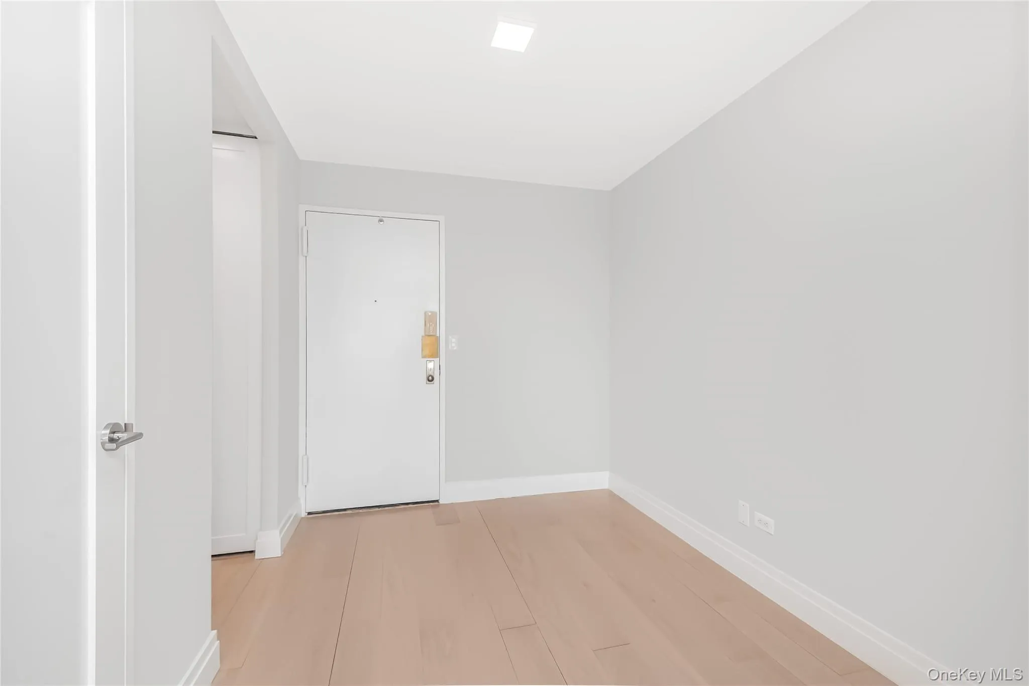 Spare room featuring baseboards and light wood-style flooring Spare room featuring baseboards and light wood-style flooring