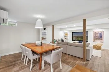 Dining room featuring a wall mounted AC and wood-type flooring