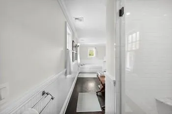 Bathroom with shower with separate bathtub, ornamental molding, and hardwood / wood-style flooring