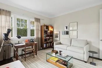 Living room with hardwood / wood-style flooring and ornamental molding