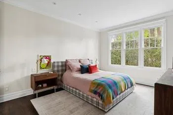 Bedroom with wood-type flooring and ornamental molding