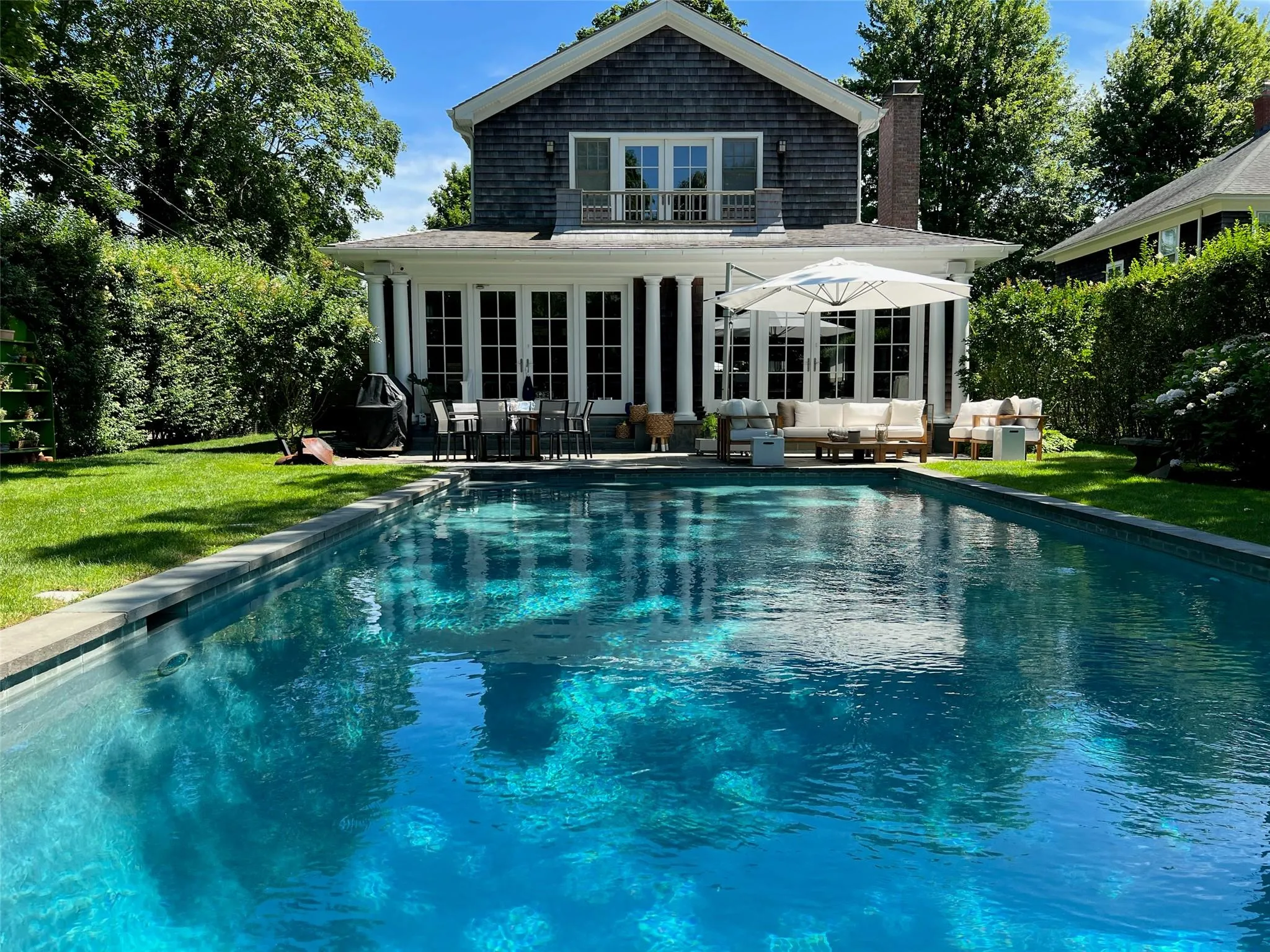 Back of property with a patio area, an outdoor living space, and a yard