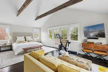Bedroom with beam ceiling, access to exterior, dark hardwood / wood-style floors, and high vaulted ceiling