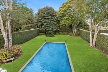 View of swimming pool featuring a lawn