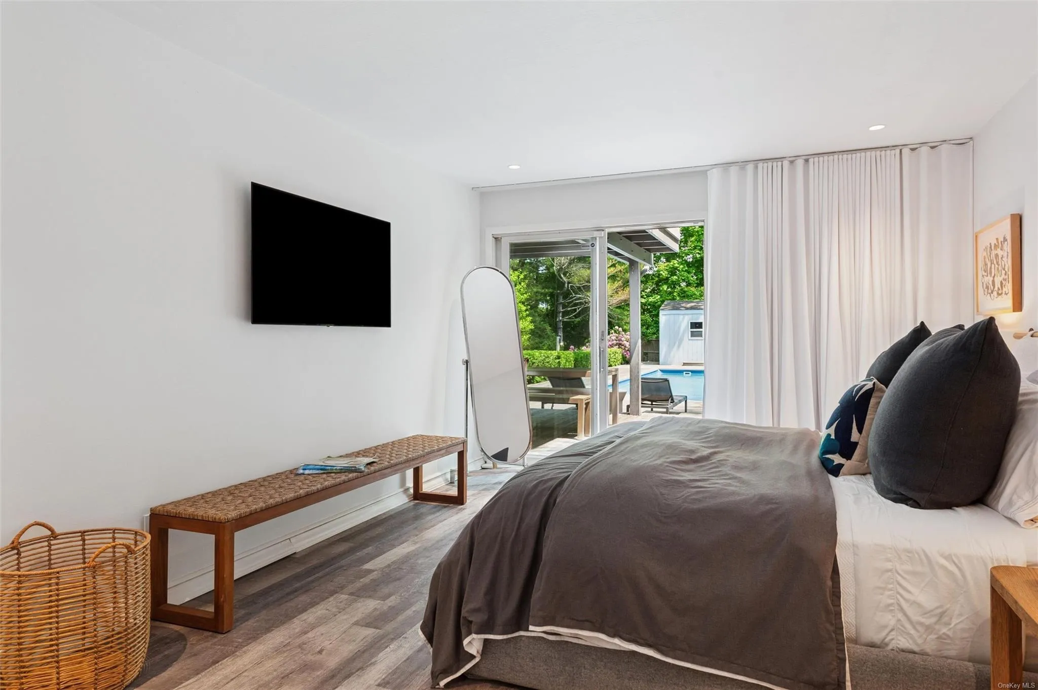 Bedroom featuring wood finished floors, access to exterior, and recessed lighting Bedroom featuring wood finished floors, access to exterior, and recessed lighting
