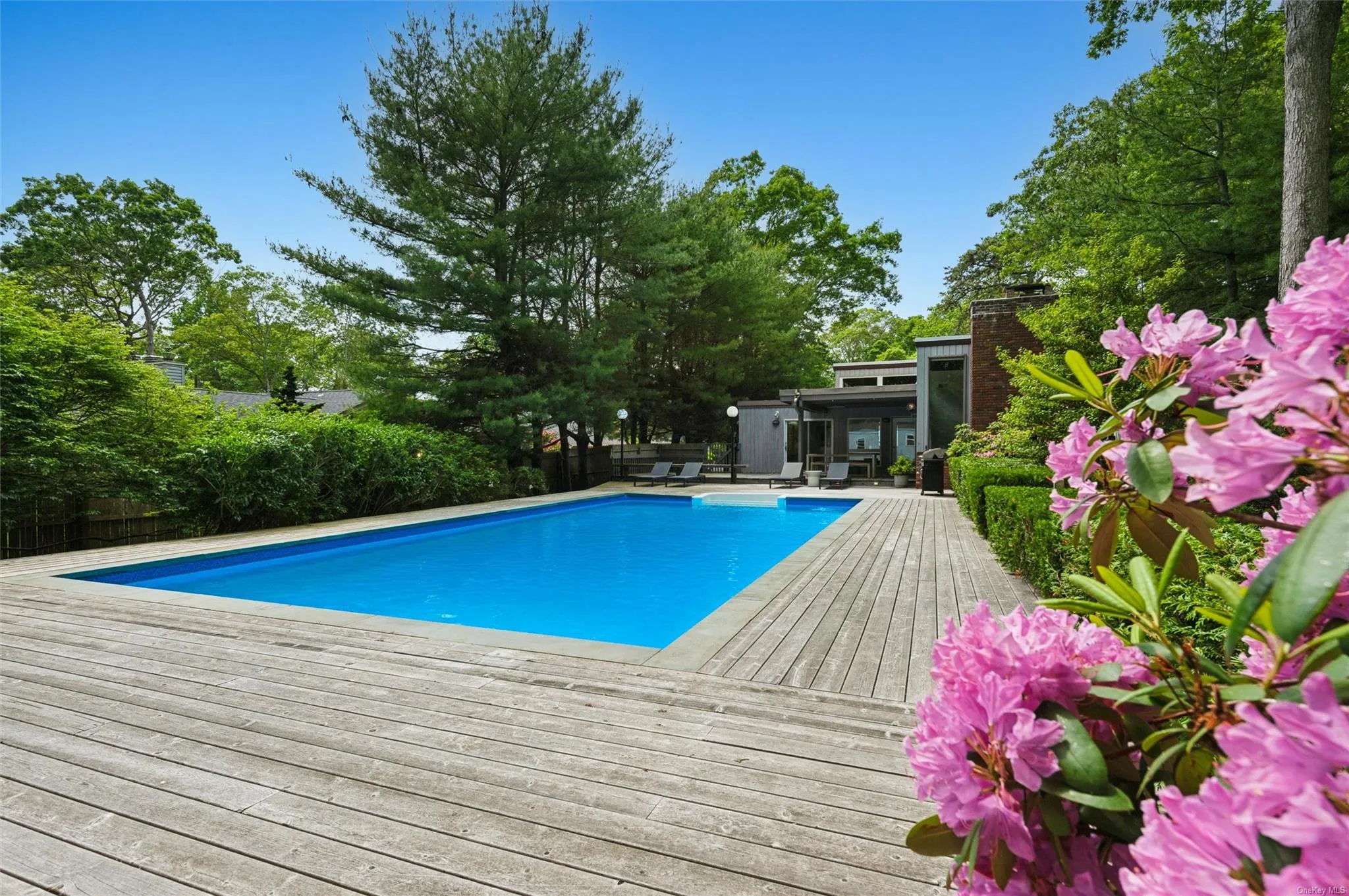 View of swimming pool featuring a wooden deck View of swimming pool featuring a wooden deck