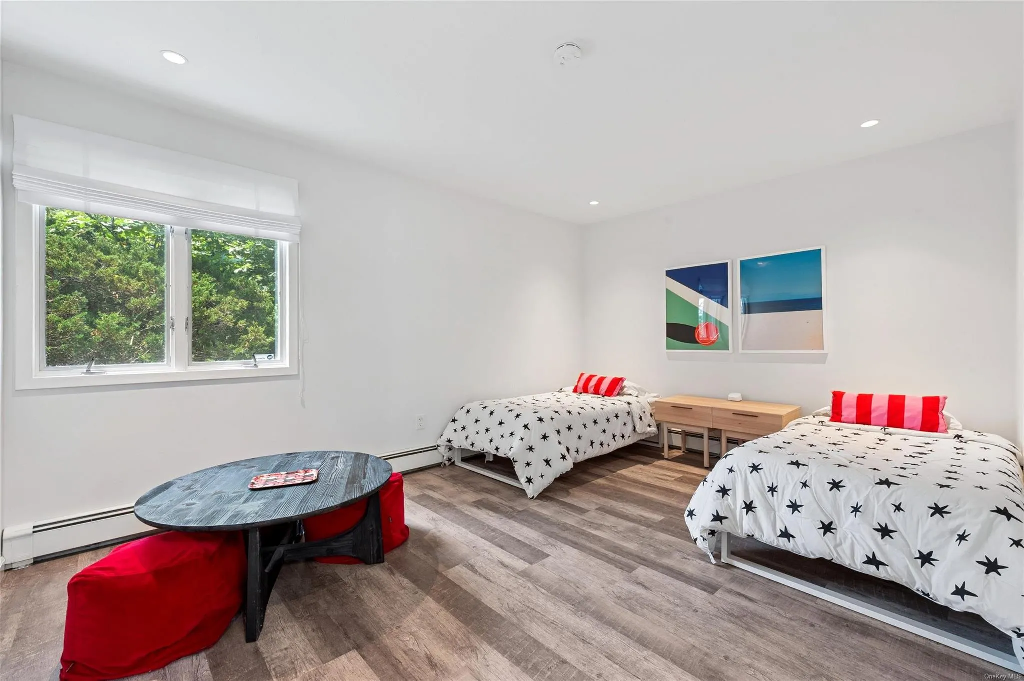 Bedroom with a baseboard radiator, wood finished floors, and recessed lighting Bedroom with a baseboard radiator, wood finished floors, and recessed lighting