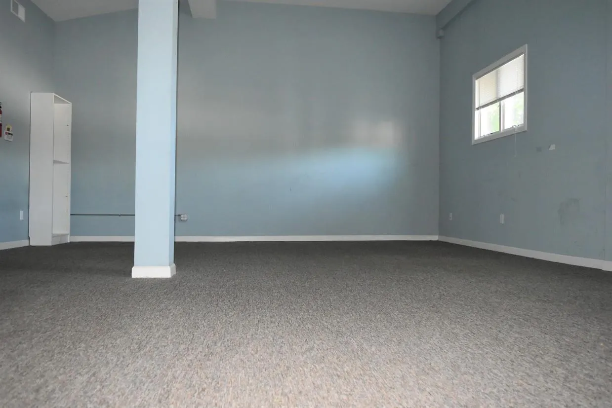 Spare room featuring dark carpet Spare room featuring dark carpet