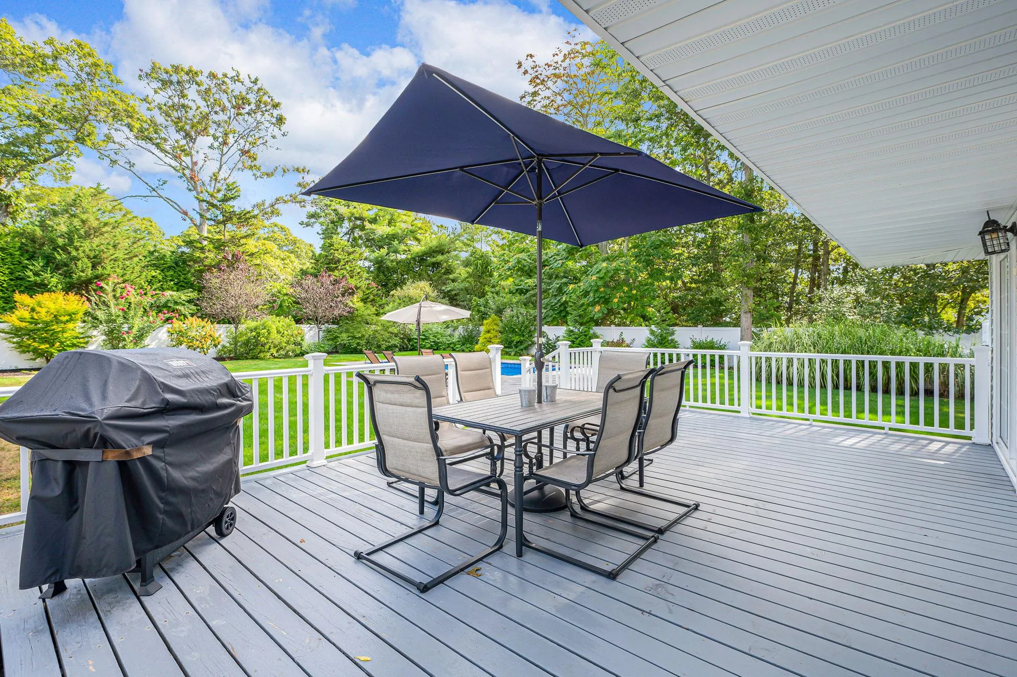 Wooden terrace with outdoor dining space and grilling area Wooden terrace with outdoor dining space and grilling area