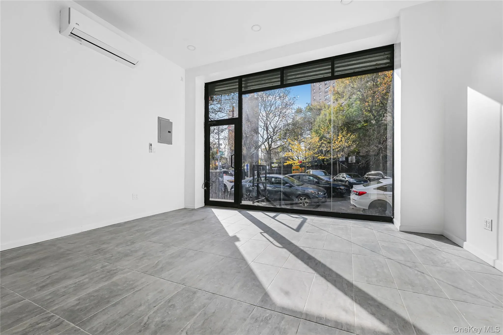 Empty room featuring electric panel and a wall unit AC Empty room featuring electric panel and a wall unit AC