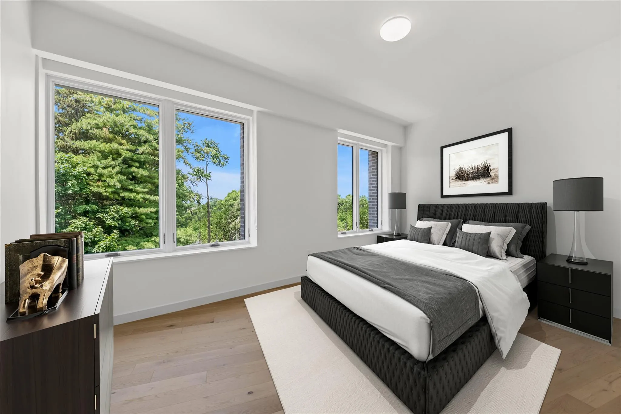 Bedroom featuring light wood-type flooring and baseboards Bedroom featuring light wood-type flooring and baseboards