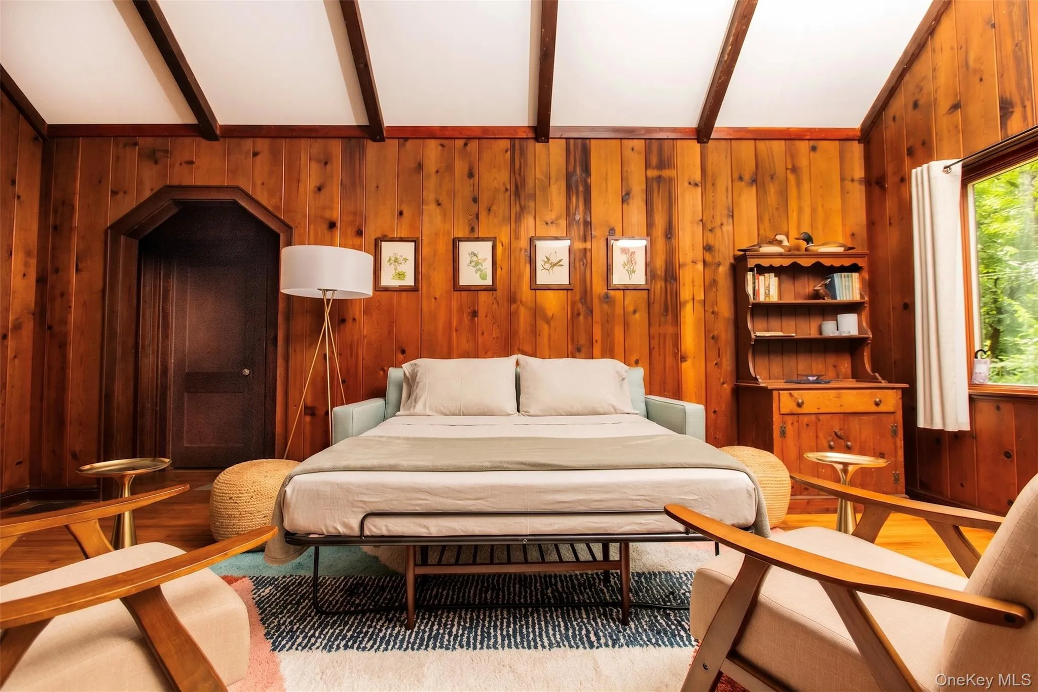 Spacious living room with working fireplace, pull out queen sofa bed, smart TV, and cozy modern furnishings. Spacious living room with working fireplace, pull out queen sofa bed, smart TV, and cozy modern furnishings.