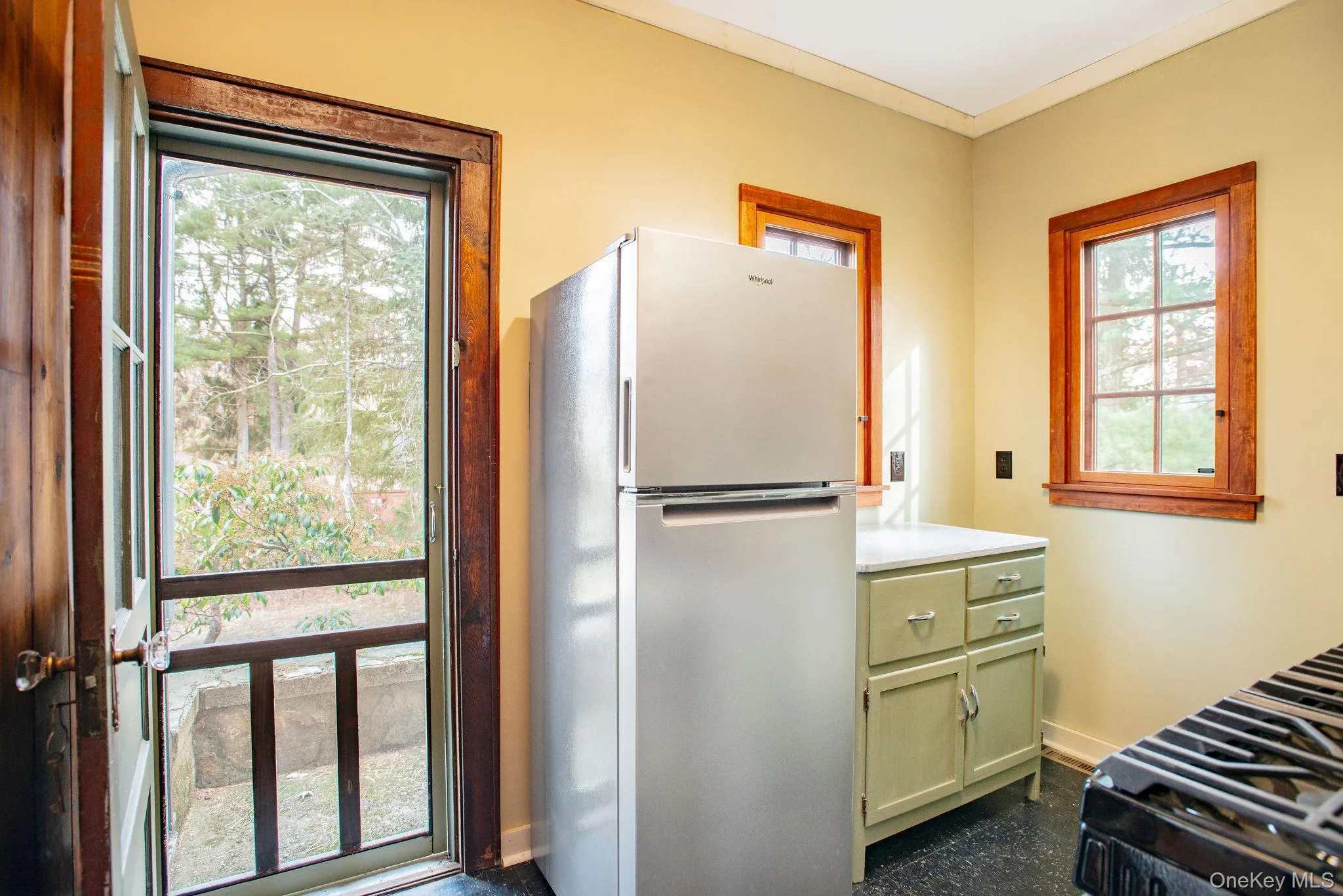 Kitchen with gas stove and microwave, leading to back yard. Kitchen with gas stove and microwave, leading to back yard.