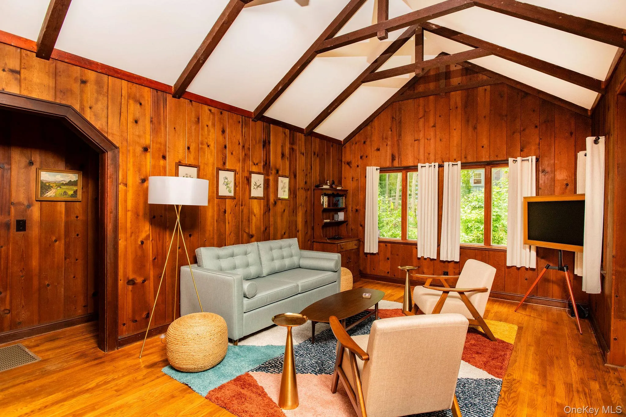 Spacious living room with working fireplace, pull out queen sofa bed, smart TV, and cozy modern furnishings. Spacious living room with working fireplace, pull out queen sofa bed, smart TV, and cozy modern furnishings.