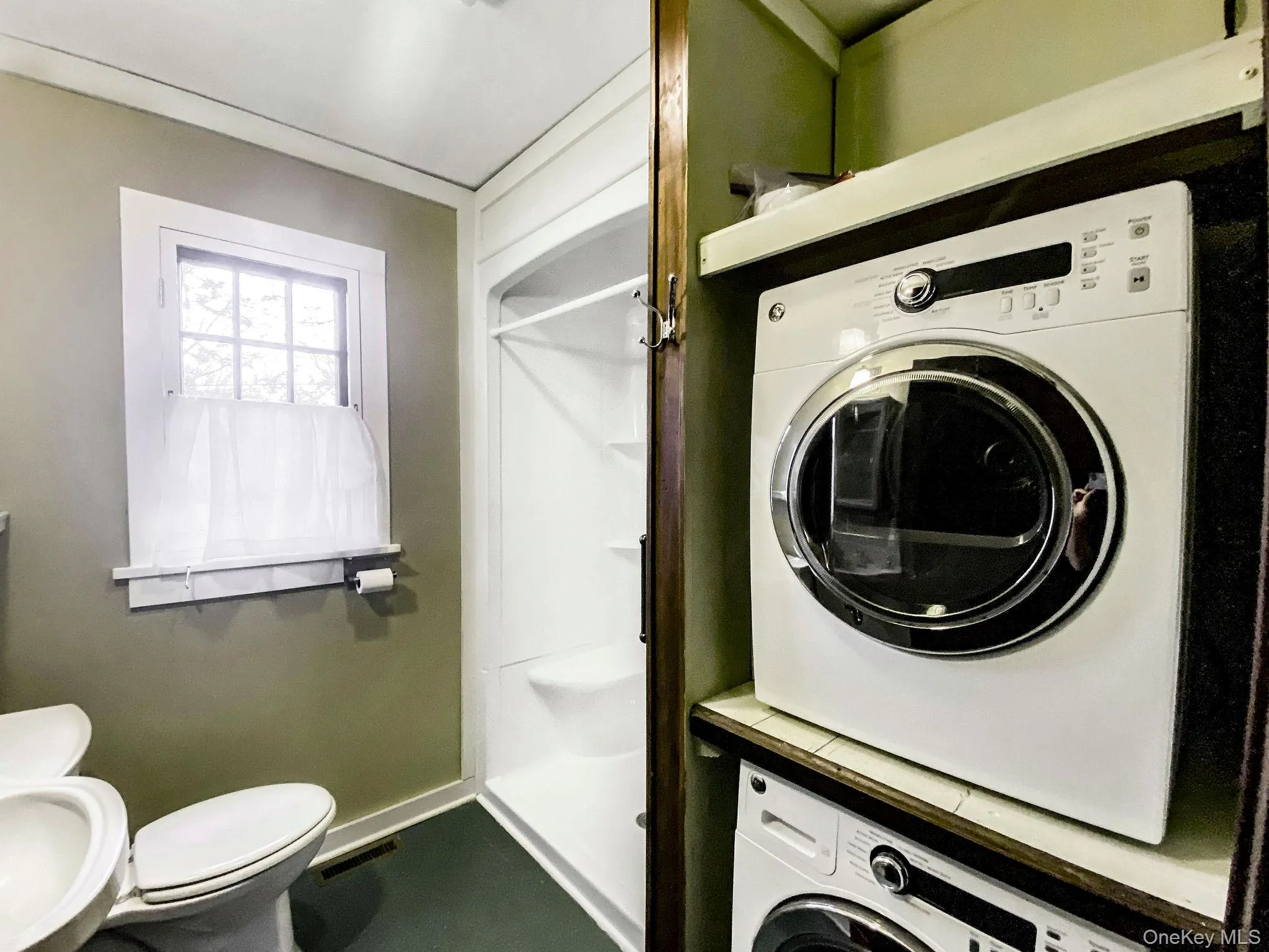 Bathroom with shower, washer and dryer. Bathroom with shower, washer and dryer.