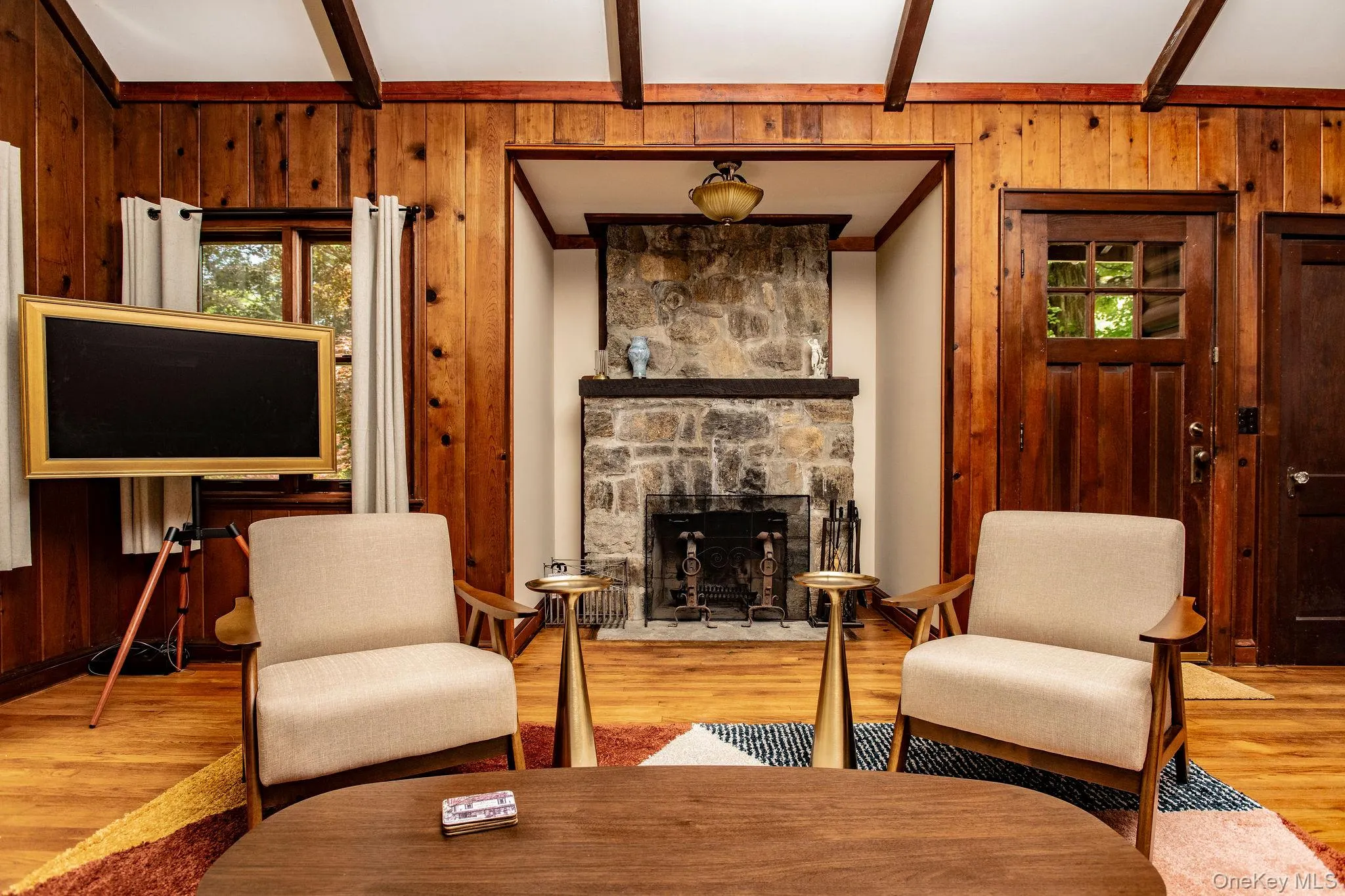 Spacious living room with working fireplace, pull out queen sofa bed, smart TV, and cozy modern furnishings. Spacious living room with working fireplace, pull out queen sofa bed, smart TV, and cozy modern furnishings.