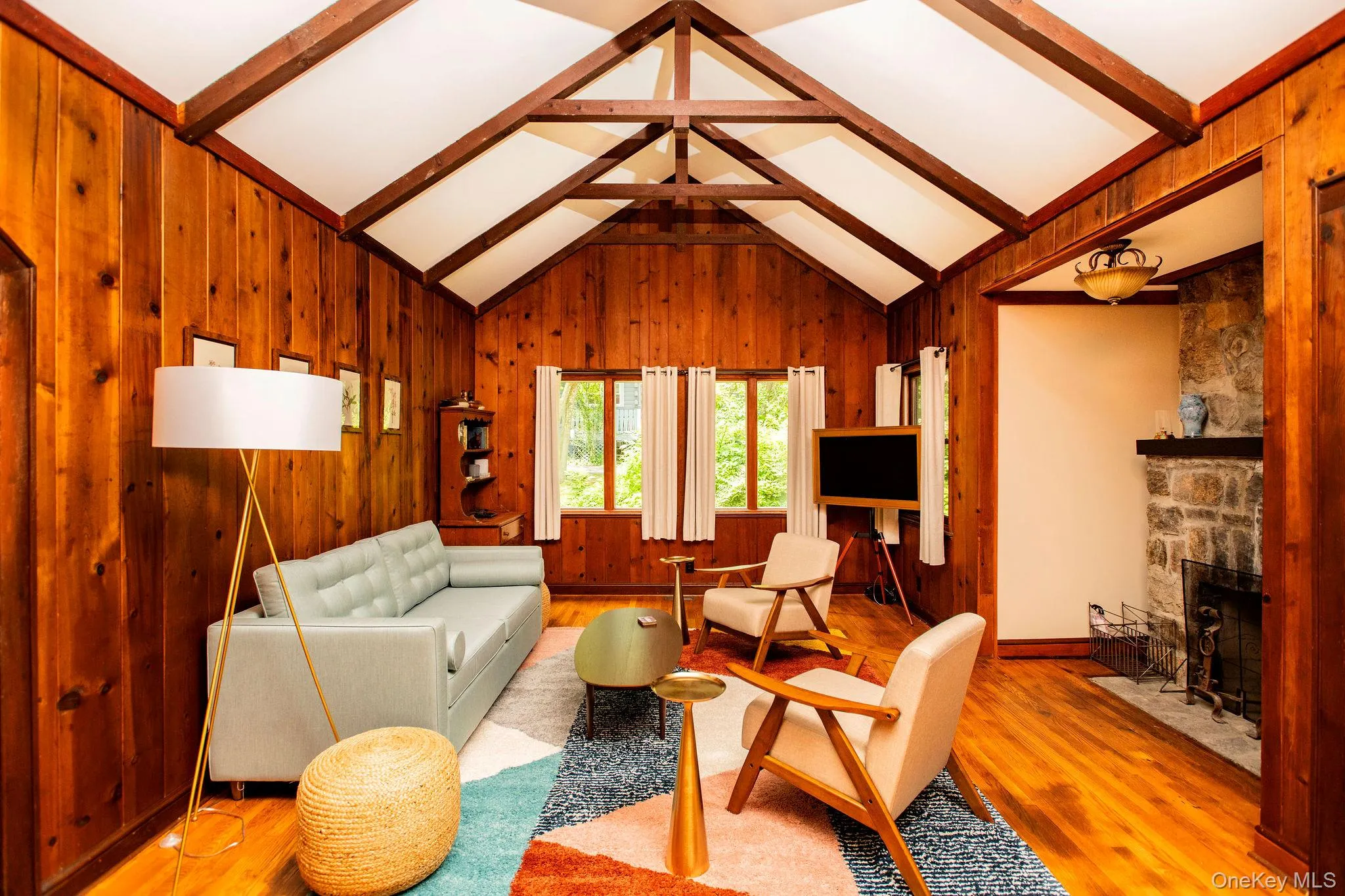 Spacious living room with working fireplace, pull out queen sofa bed, smart TV, and cozy modern furnishings. Spacious living room with working fireplace, pull out queen sofa bed, smart TV, and cozy modern furnishings.