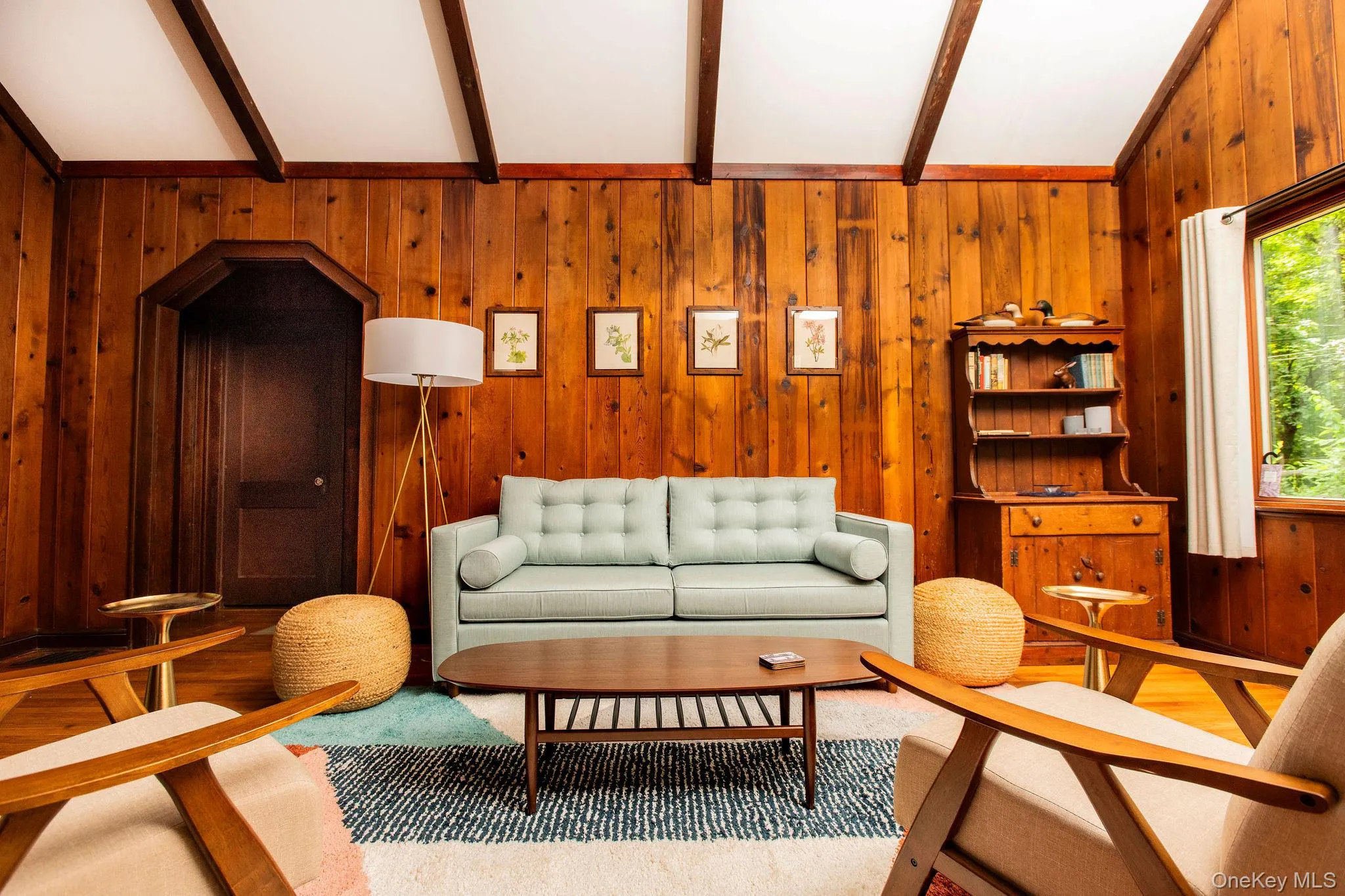 Spacious living room with working fireplace, pull out queen sofa bed, smart TV, and cozy modern furnishings. Spacious living room with working fireplace, pull out queen sofa bed, smart TV, and cozy modern furnishings.