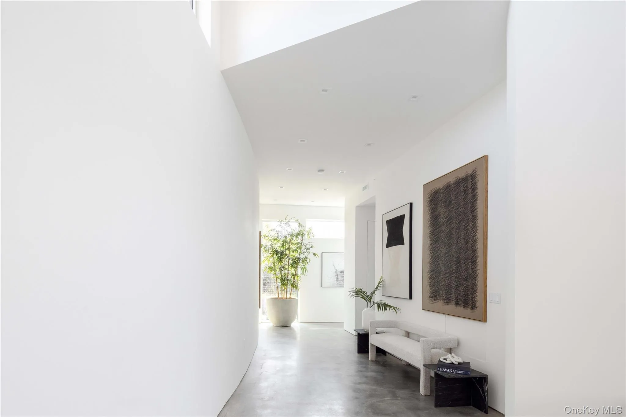 Hallway featuring concrete flooring Hallway featuring concrete flooring