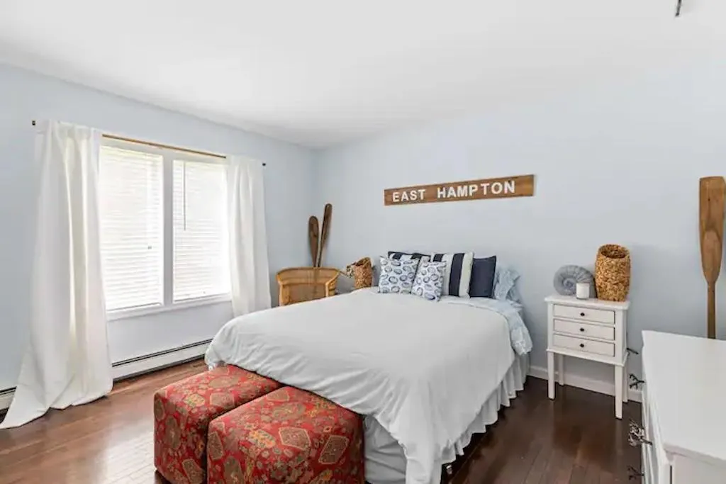 Bedroom featuring dark hardwood / wood-style floors and a baseboard radiator Bedroom featuring dark hardwood / wood-style floors and a baseboard radiator