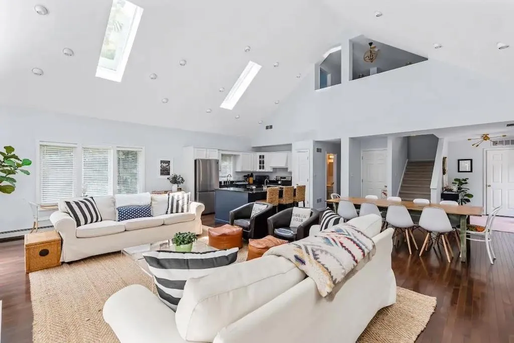 Living room featuring ceiling fan, dark hardwood / wood-style flooring, and high vaulted ceiling Living room featuring ceiling fan, dark hardwood / wood-style flooring, and high vaulted ceiling