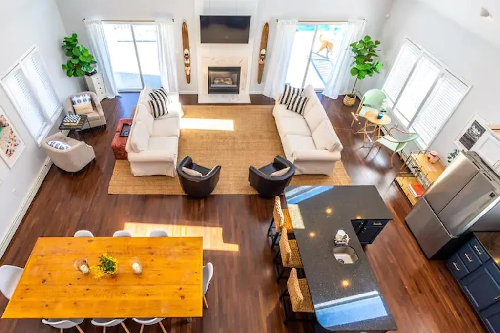 Living room with a towering ceiling and dark wood-type flooring Living room with a towering ceiling and dark wood-type flooring