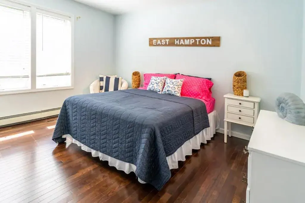 Bedroom featuring dark hardwood / wood-style flooring and baseboard heating Bedroom featuring dark hardwood / wood-style flooring and baseboard heating