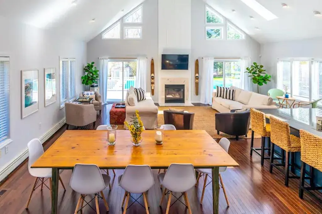 Dining area featuring plenty of natural light, dark wood-type flooring, and high vaulted ceiling Dining area featuring plenty of natural light, dark wood-type flooring, and high vaulted ceiling