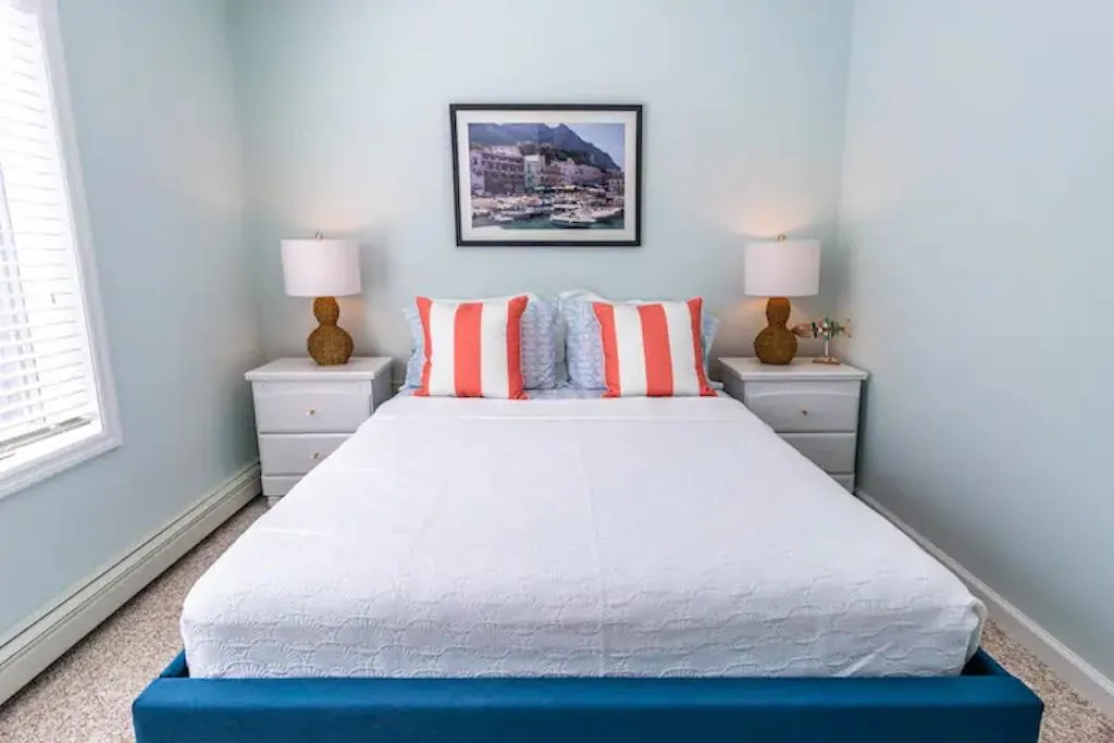 Carpeted bedroom with a baseboard radiator Carpeted bedroom with a baseboard radiator