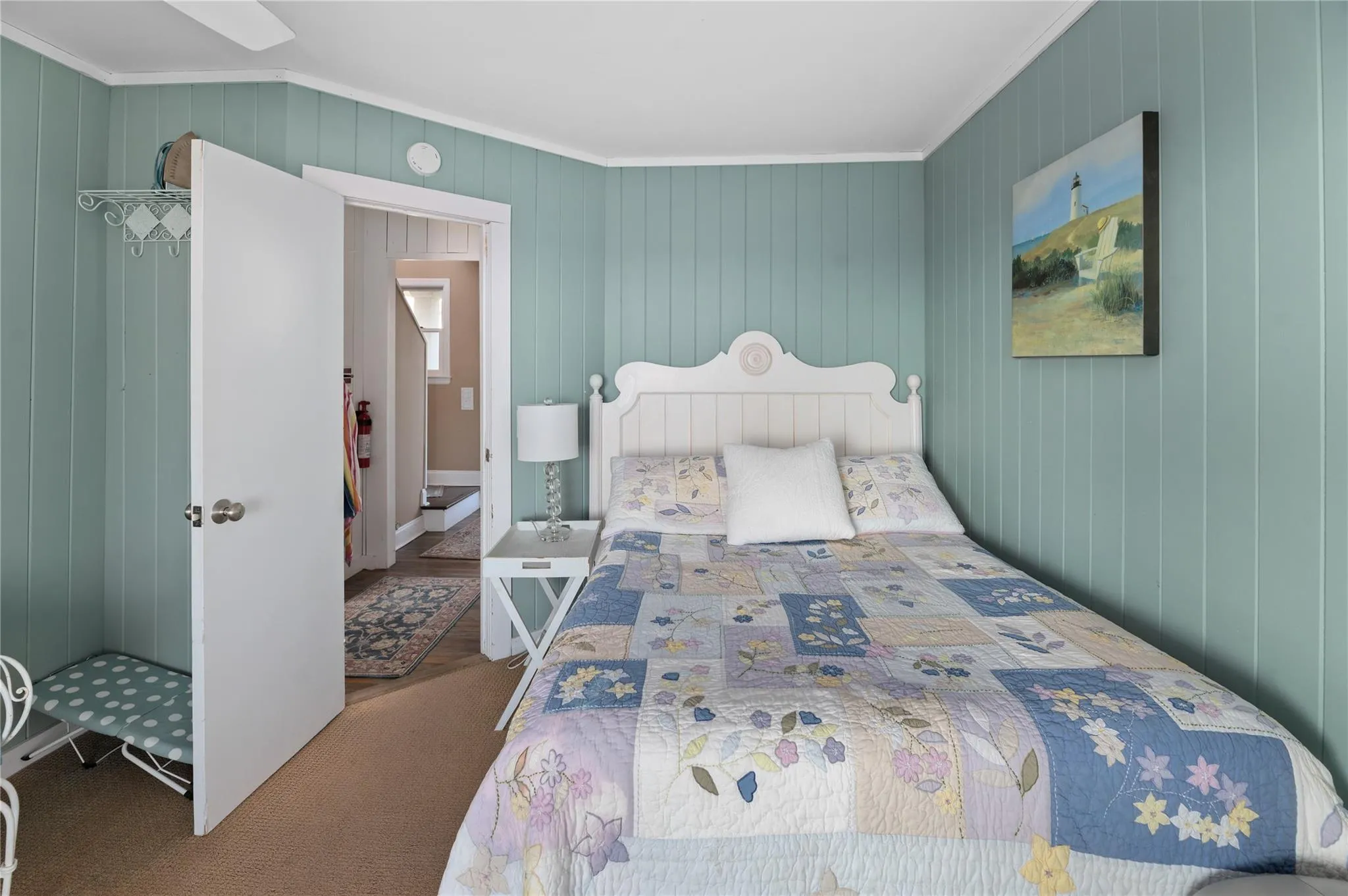 Bedroom featuring crown molding and wood walls Bedroom featuring crown molding and wood walls