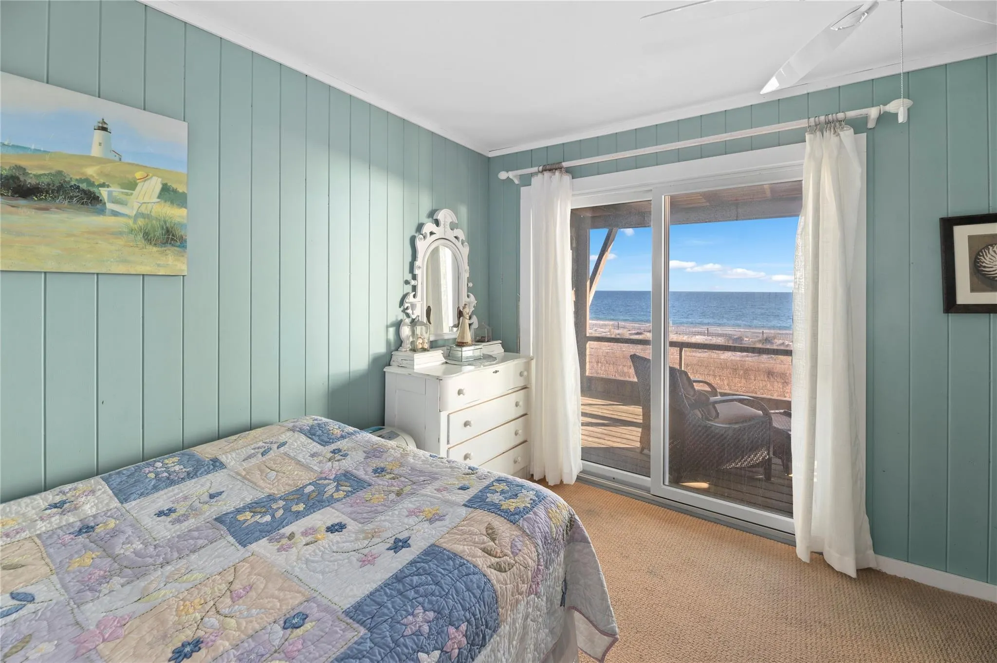 Bedroom with a water view, crown molding, ceiling fan, access to exterior, and light colored carpet Bedroom with a water view, crown molding, ceiling fan, access to exterior, and light colored carpet