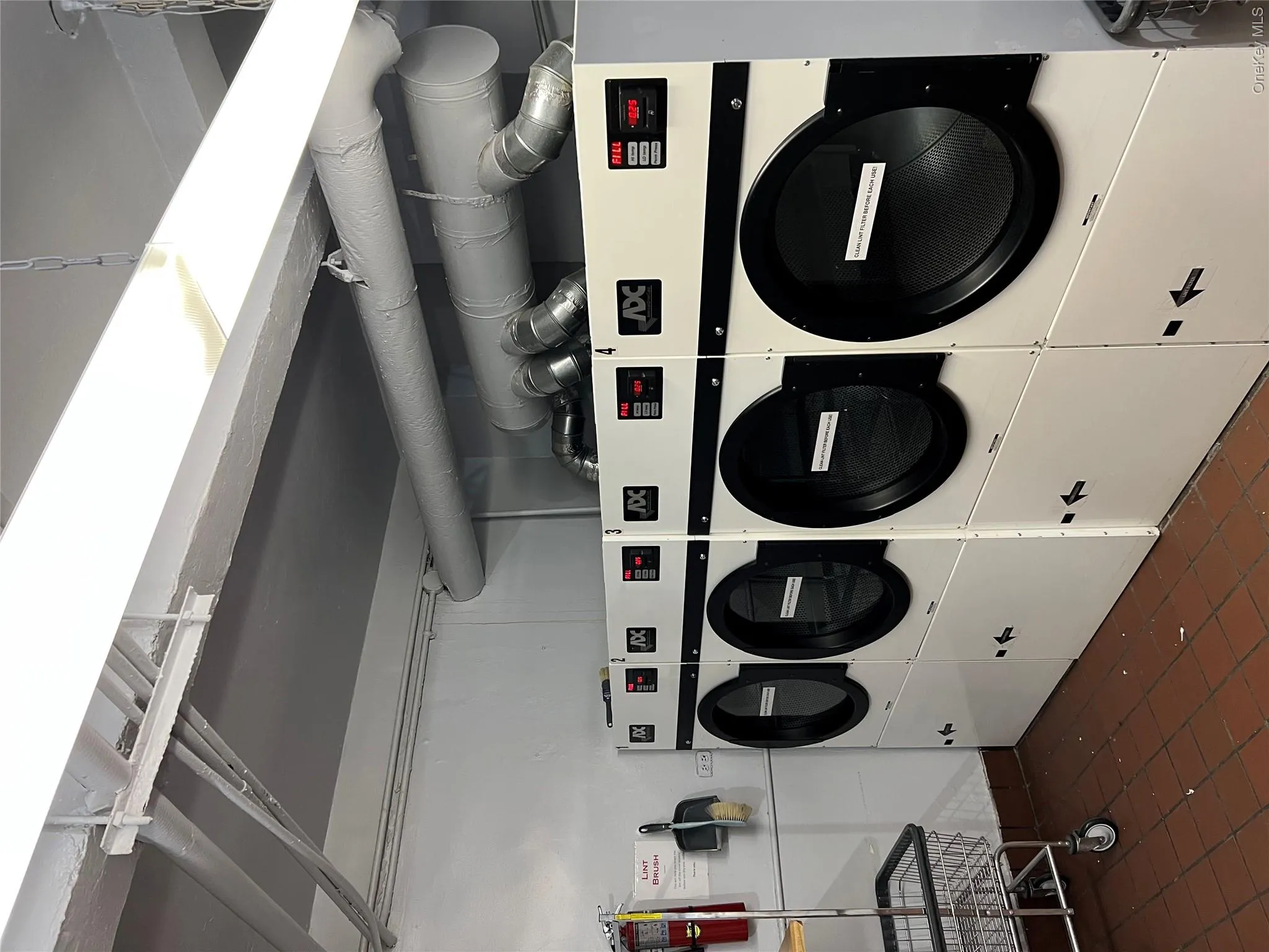 Clothes washing area featuring separate washer and dryer and dark tile patterned floors Clothes washing area featuring separate washer and dryer and dark tile patterned floors