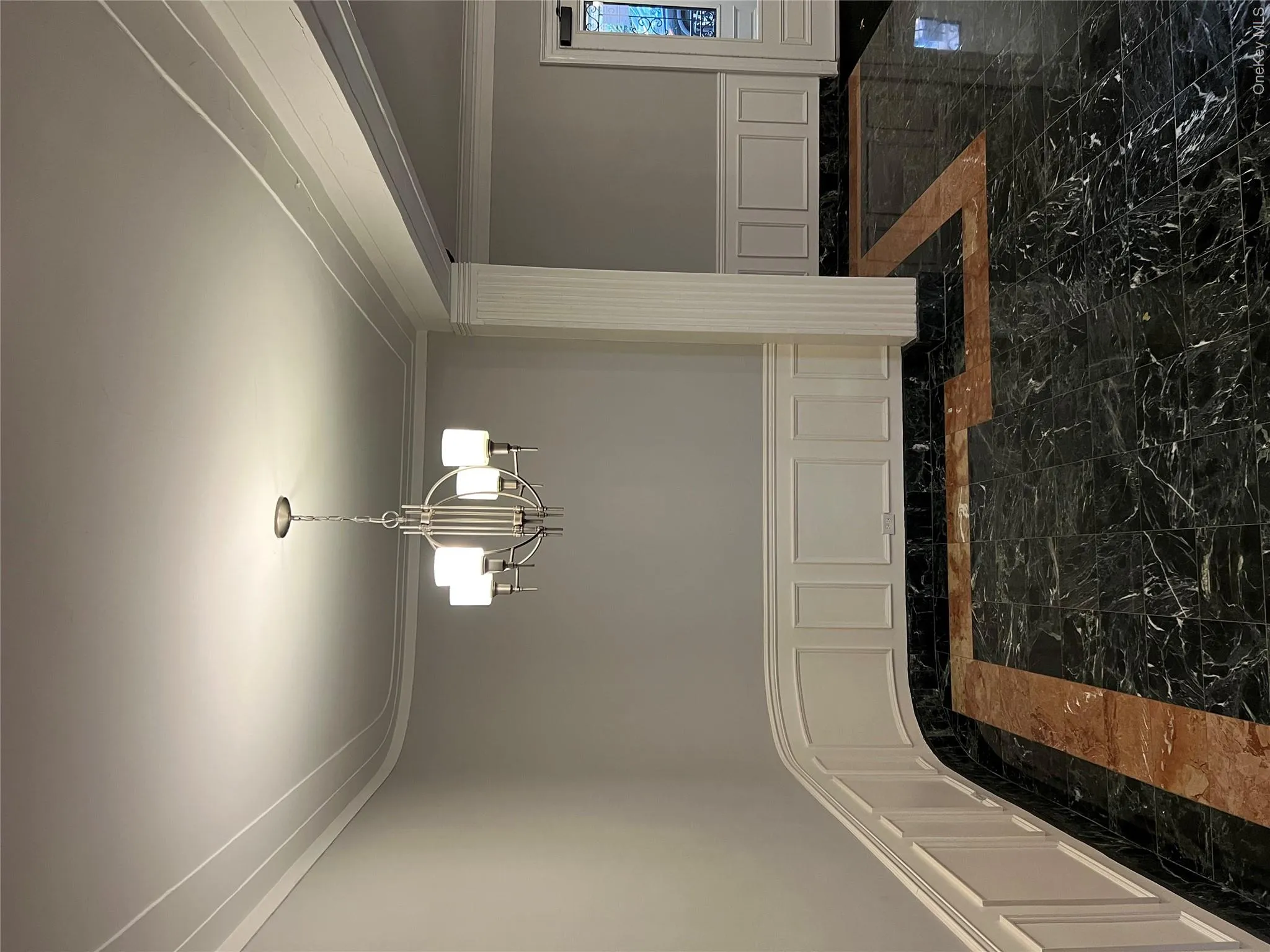 Unfurnished dining area with a notable chandelier and ornamental molding Unfurnished dining area with a notable chandelier and ornamental molding