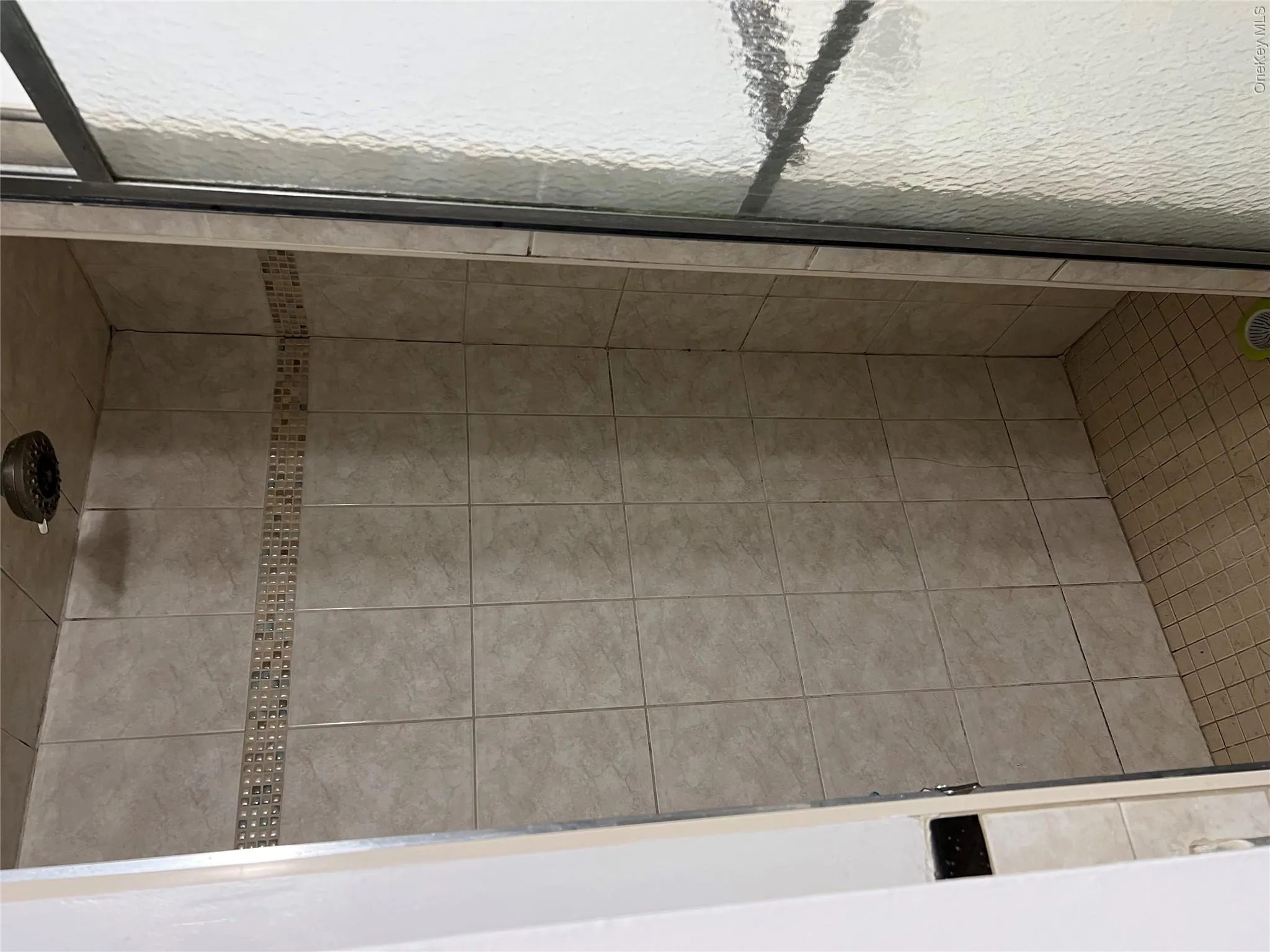 Bathroom featuring a shower with shower door Bathroom featuring a shower with shower door