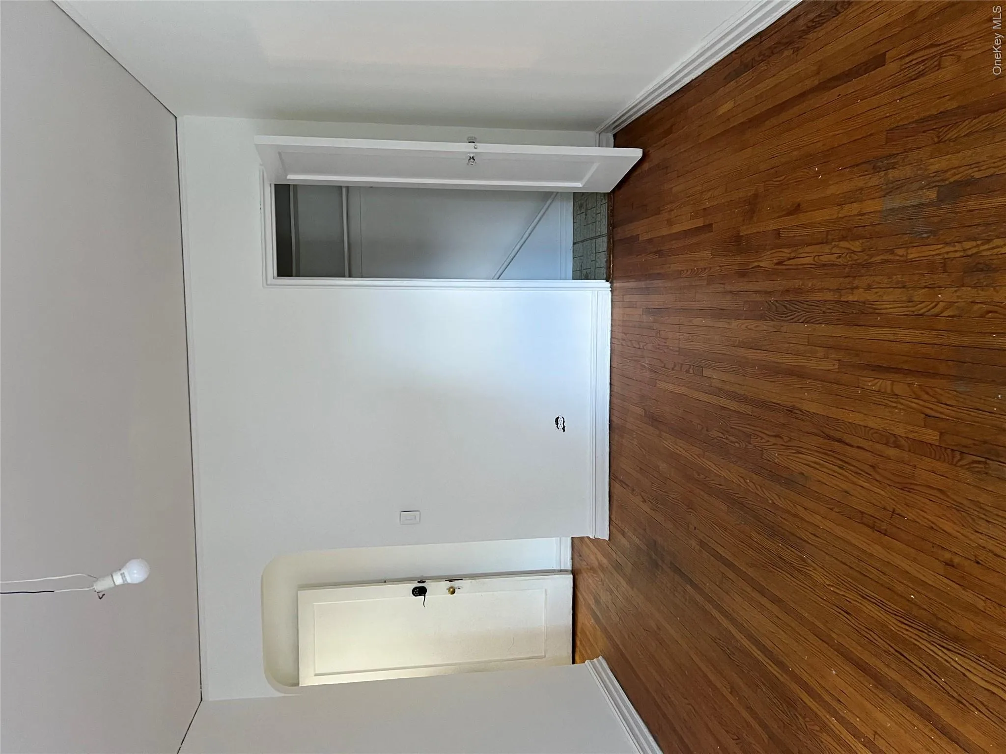 Unfurnished bedroom featuring dark hardwood / wood-style flooring Unfurnished bedroom featuring dark hardwood / wood-style flooring
