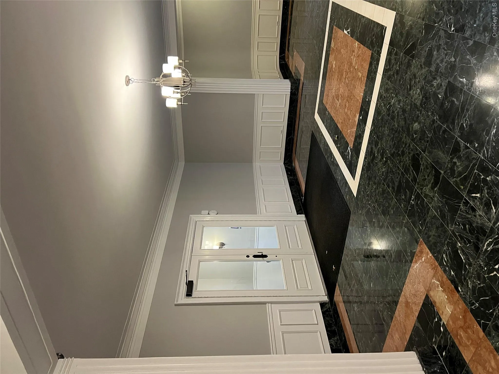 Entryway featuring crown molding and a chandelier Entryway featuring crown molding and a chandelier