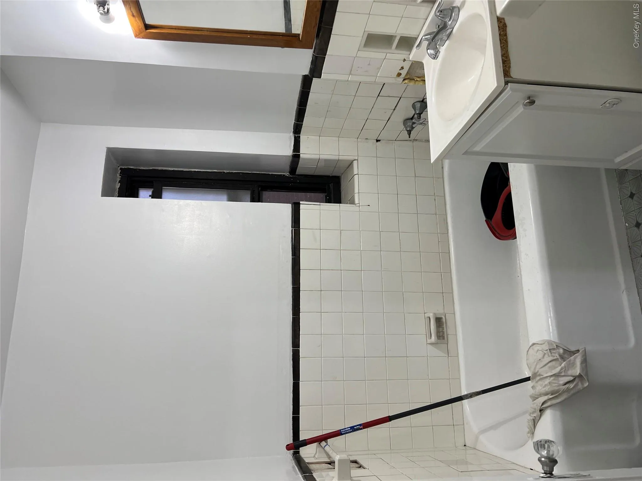 Bathroom with a washtub, vanity, and tile walls Bathroom with a washtub, vanity, and tile walls
