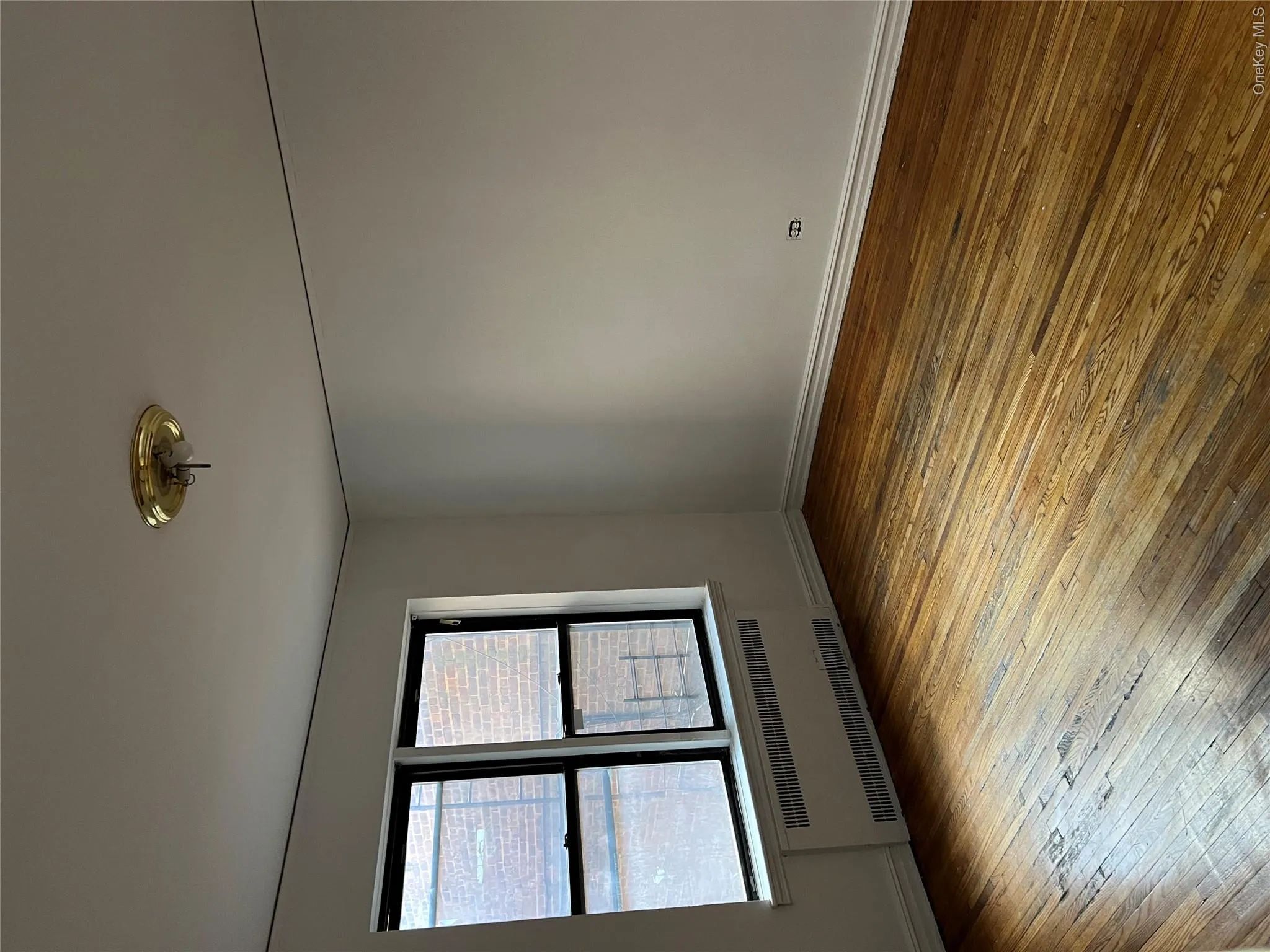 Empty room with hardwood / wood-style floors and radiator Empty room with hardwood / wood-style floors and radiator